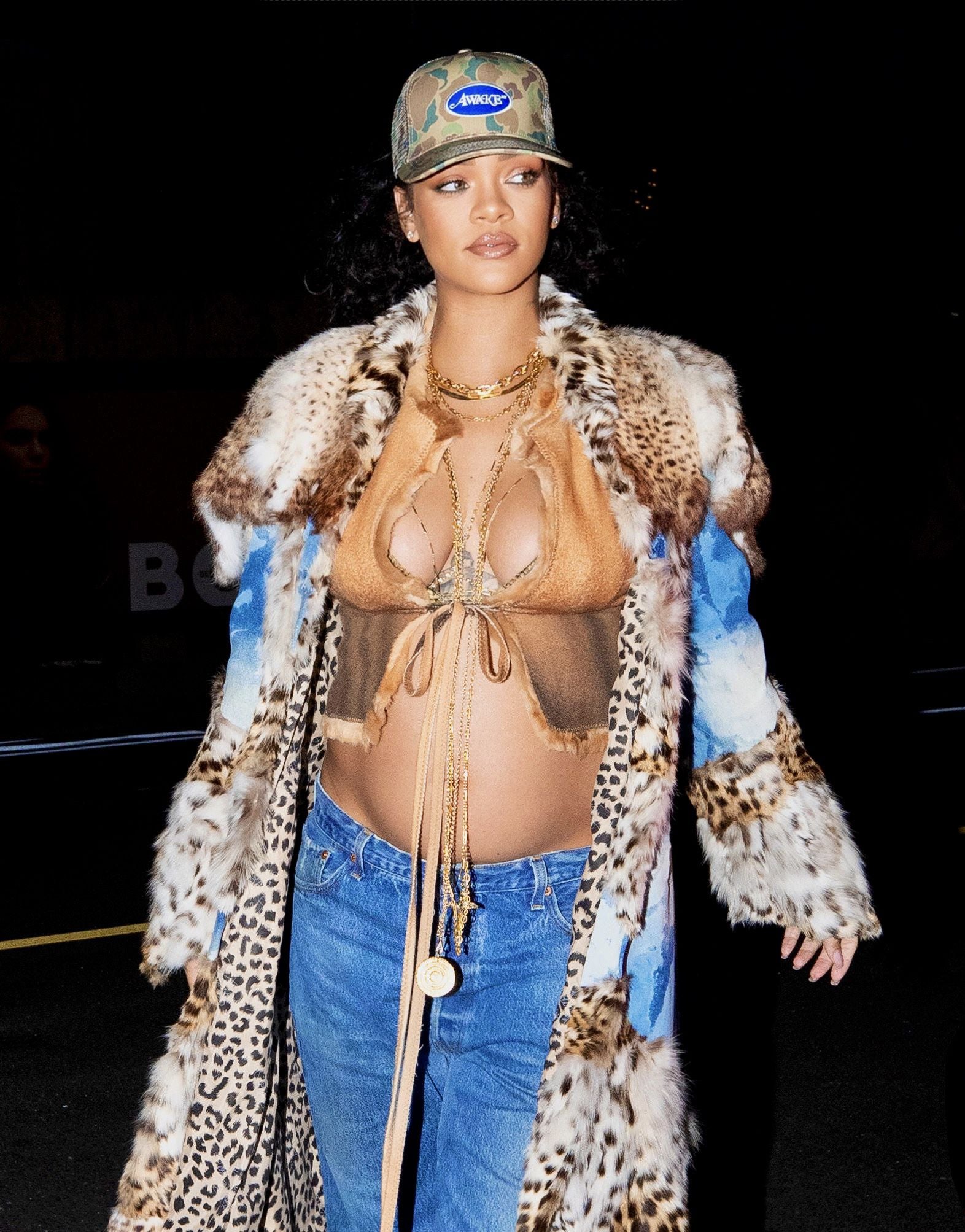 Rihanna unleashes her wild side as she drapes her growing baby bump in fur coat for dinner