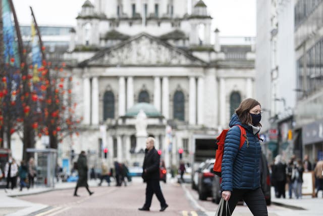 A woman wears a face mask in Belfast City Centre (Peter Morrison/PA)
