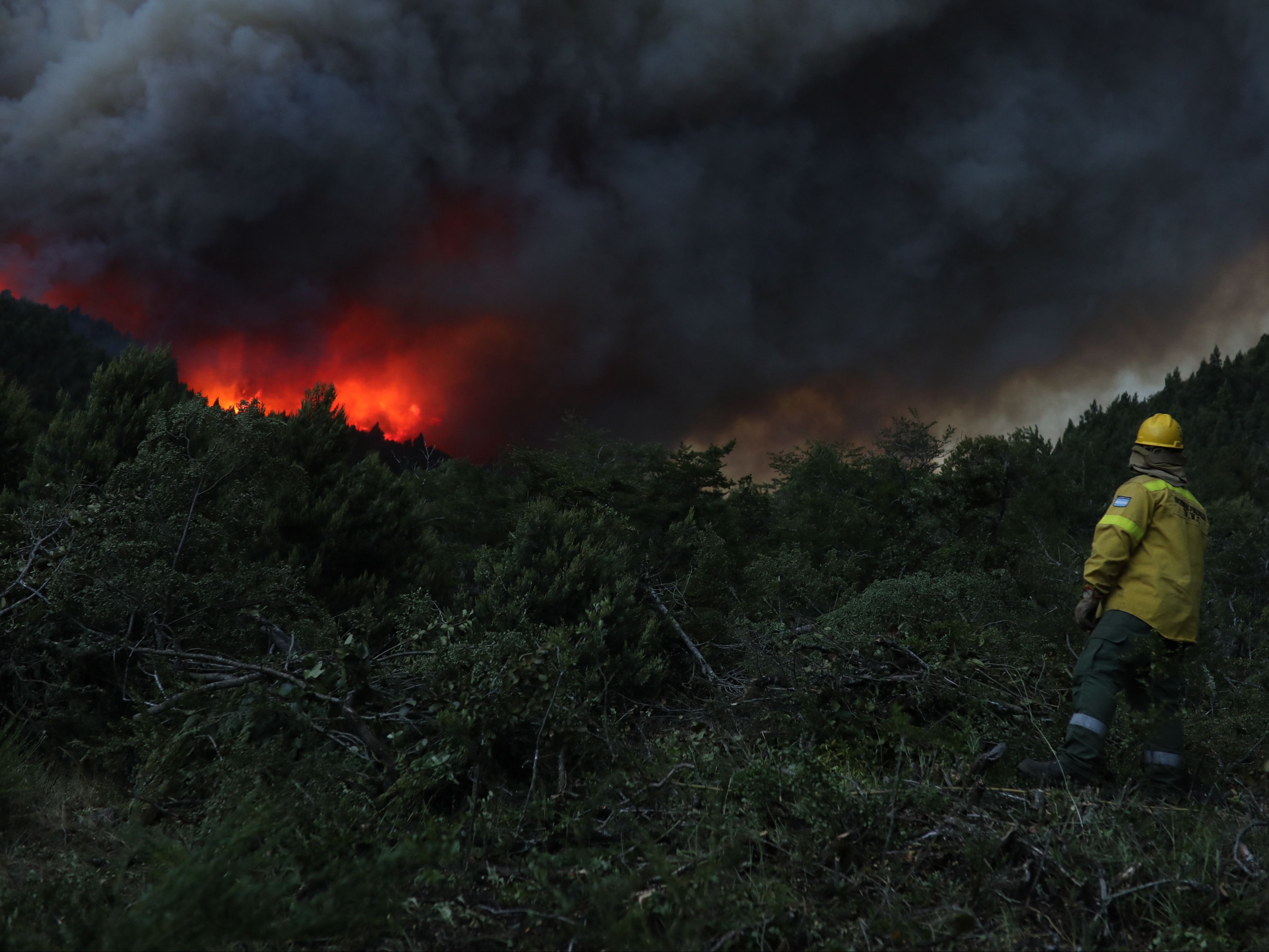 A fireman works to extinguish a fire that broke out in Paraje Villegas, Rio Negro province, 70 km south of Bariloche, Argentina
