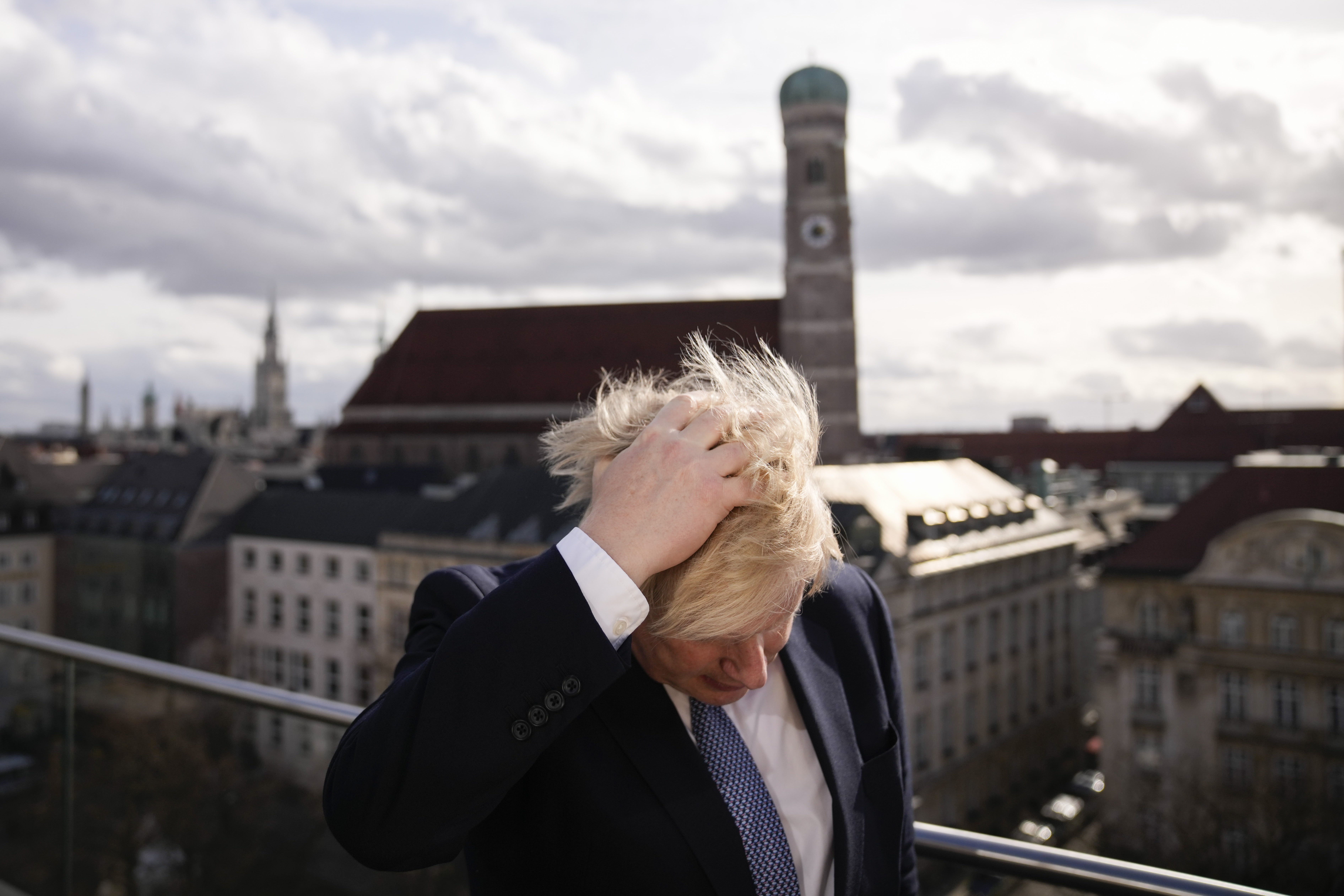 Prime Minister Boris Johnson rubbing his hair to get ready for a interview during the Munich Security Conference in Germany. (Matt Dunham/PA)