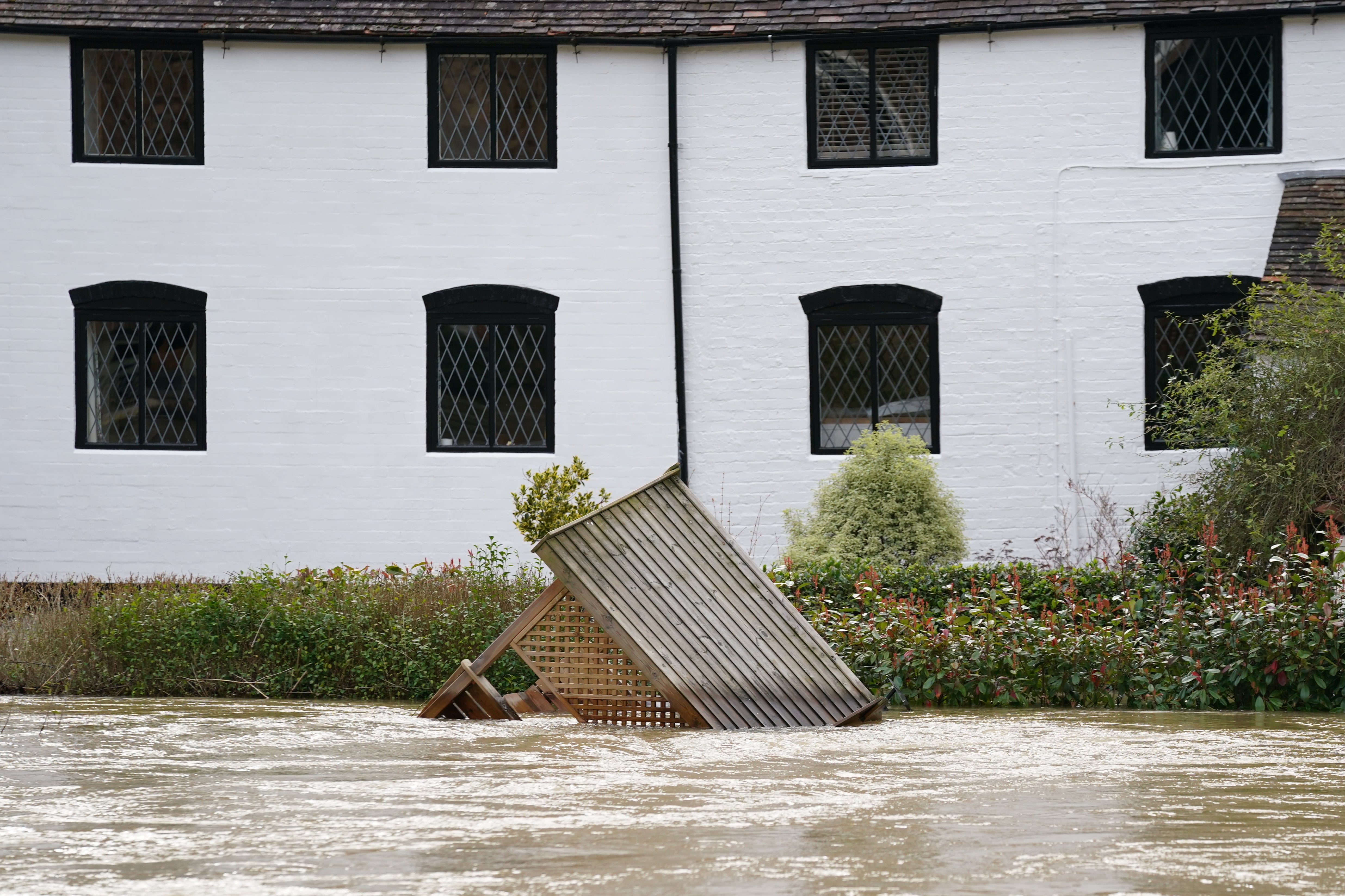 A garden arbour floats in the River Severn (Jacob King/PA)