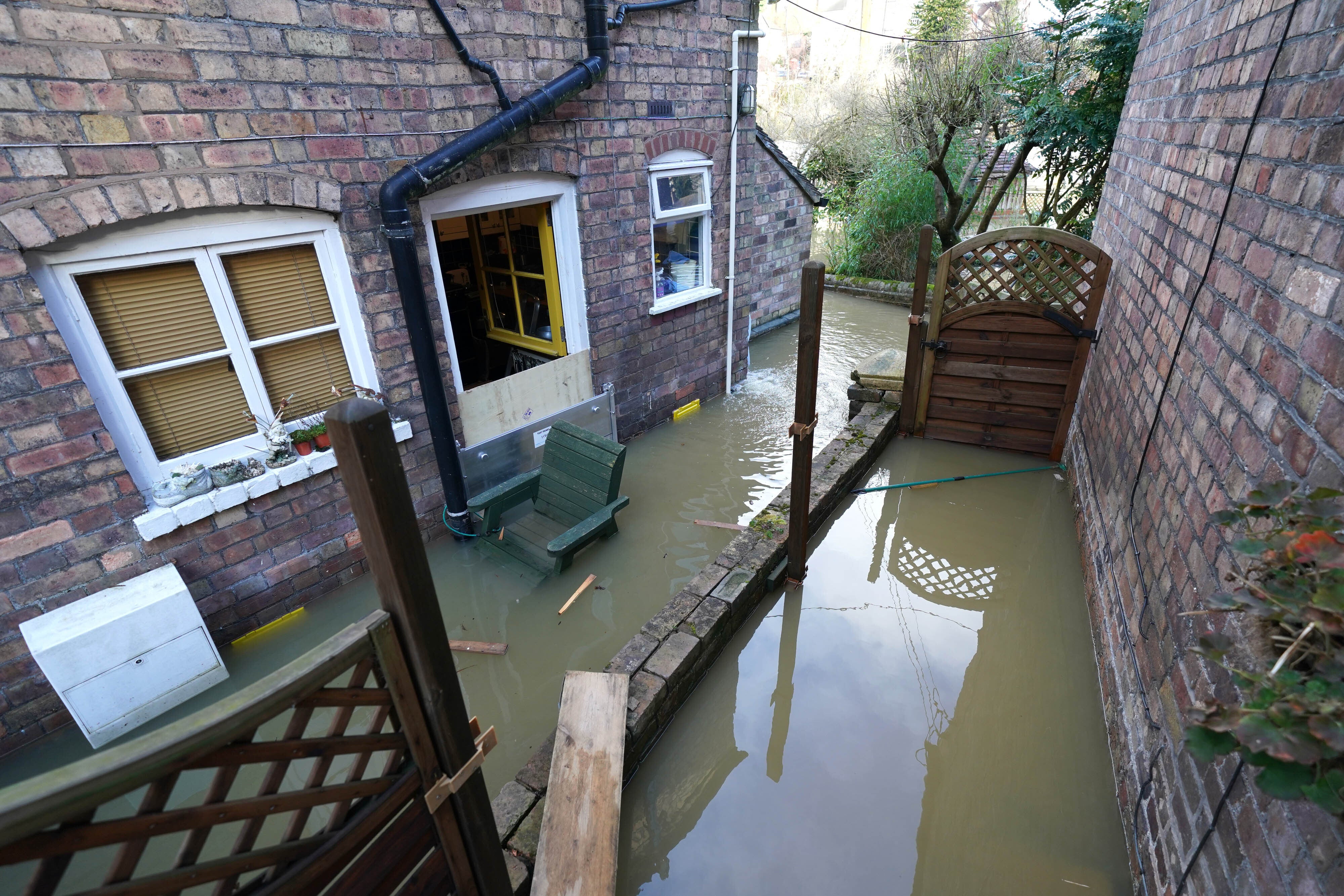 Flooded properties next to the River Severn following high winds and wet weather in Ironbridge, Shropshire (Jacob King/PA)