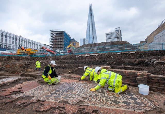 <p>MOLA archaeologists at work on the mosaic unearthed in Southwark</p>
