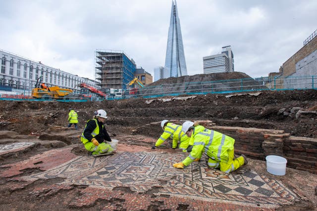 <p>MOLA archaeologists at work on the mosaic unearthed in Southwark</p>
