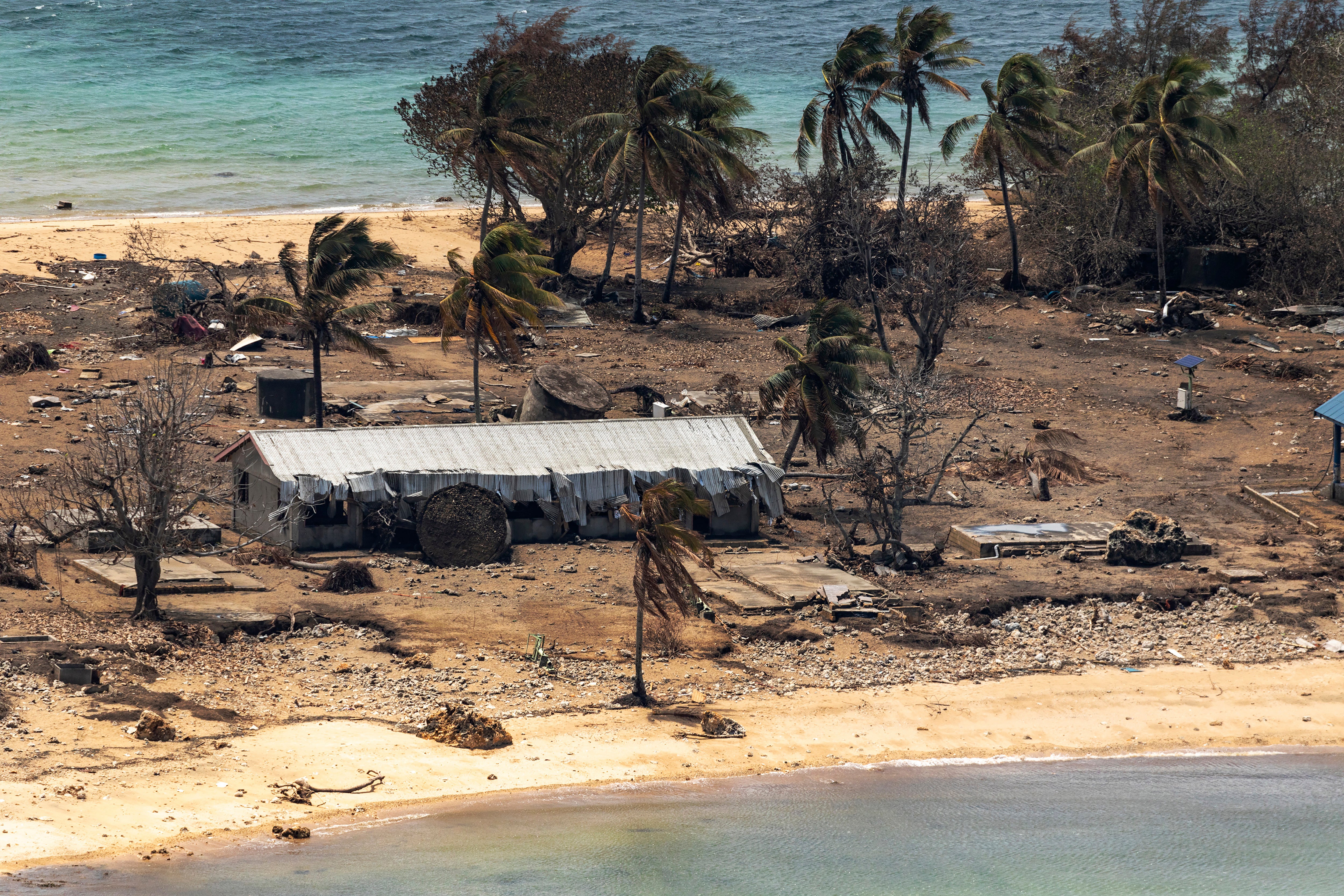 File photo: Debris from damaged buildings and trees are strewn around on Atata Island, Tonga, 28 January 2022