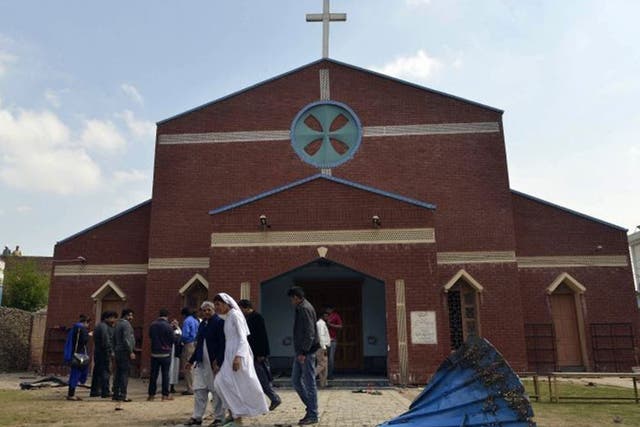 <p>Pakistani Christians gather in front of a church following the suicide bombing attacks on the churches in Lahore in  March 2015</p>