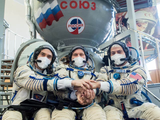 <p>Russian cosmonauts and a US astronaut pose for a photo before departing for the International Space Station on 20 March, 2021</p>