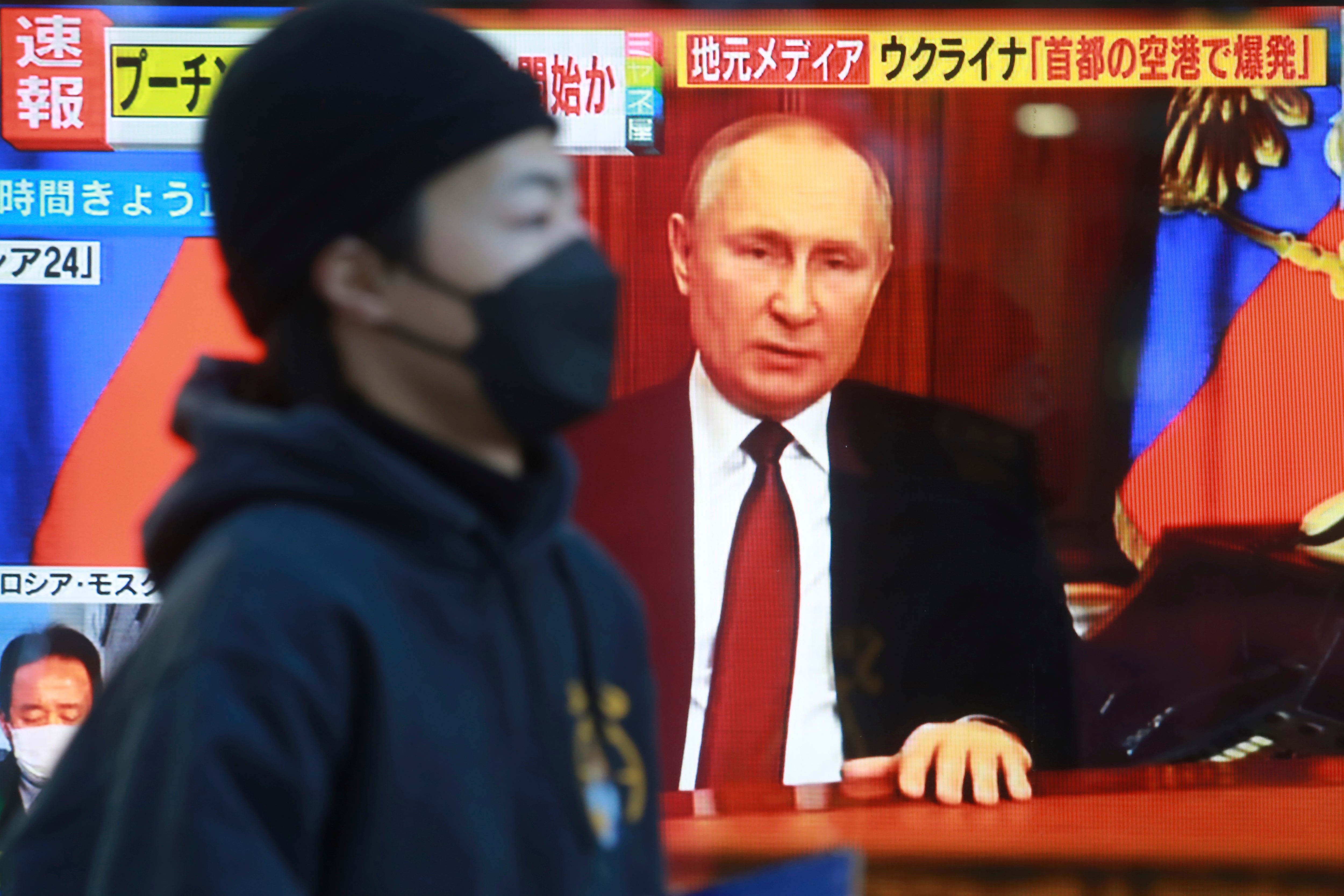 File A man walks past a TV screen with image of Russia’s President Vladimir Putin in Tokyo, Thursday, 24 Feb, 2022.