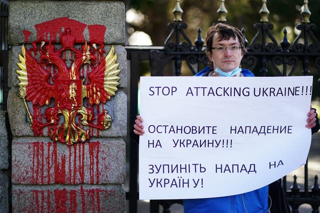 Mykhailo Makarov from Ukraine and living in Dublin protests at the entrance to the Embassy of Russia in Dublin where prior to his arrival red paint was poured on the coat of arms of the Russian Federation following the Russian invasion of Ukraine (Brian Lawless/PA)