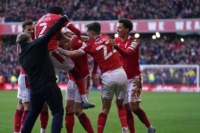 A Leicester City fan invades the pitch as Nottingham Forest players celebrate a goal (Tim Goode/PA)