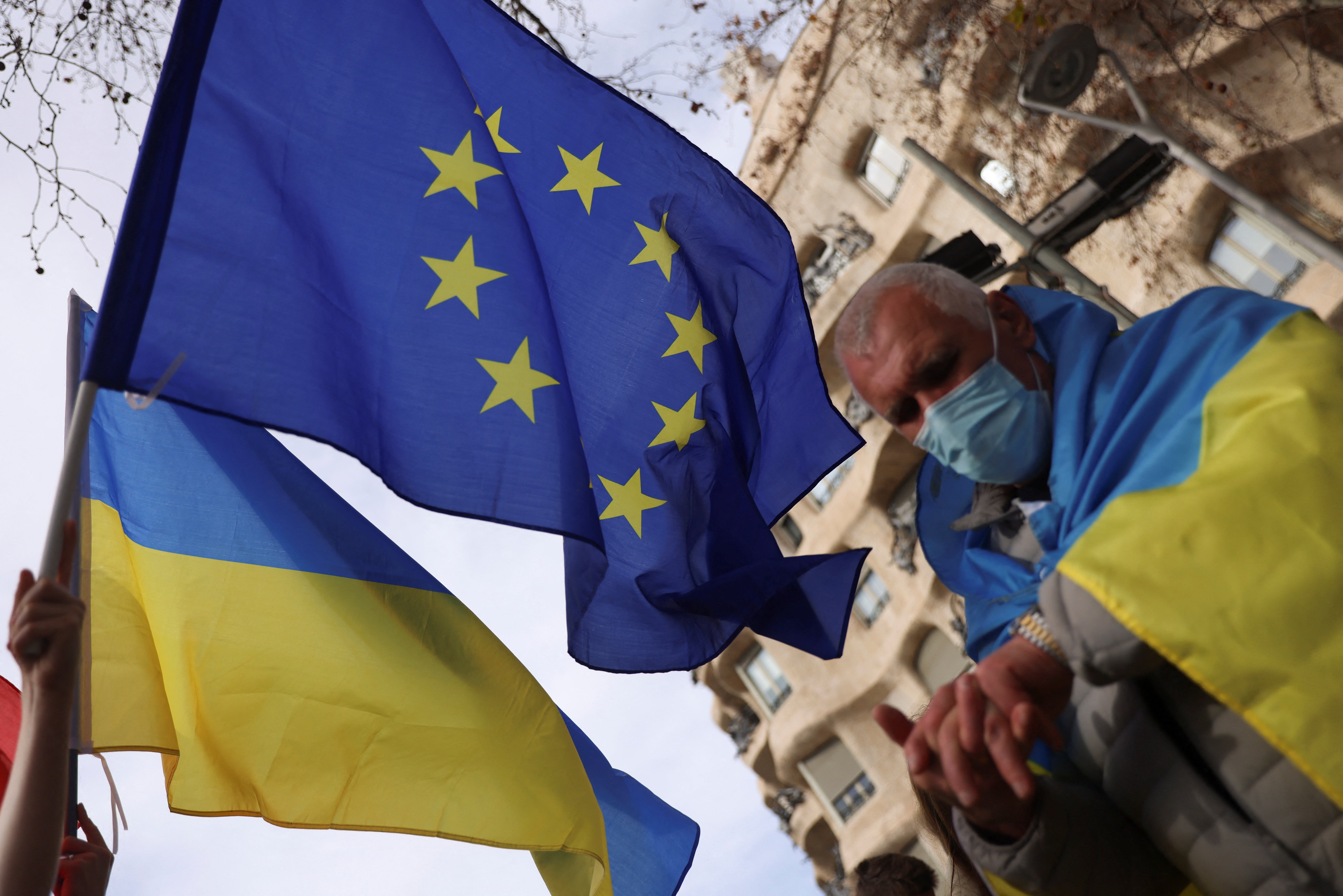 Demonstrators take part in an anti-war protest, after Russian President Vladimir Putin authorized a military operation in eastern Ukraine, in front of the European Union headquarters, in Barcelona Spain