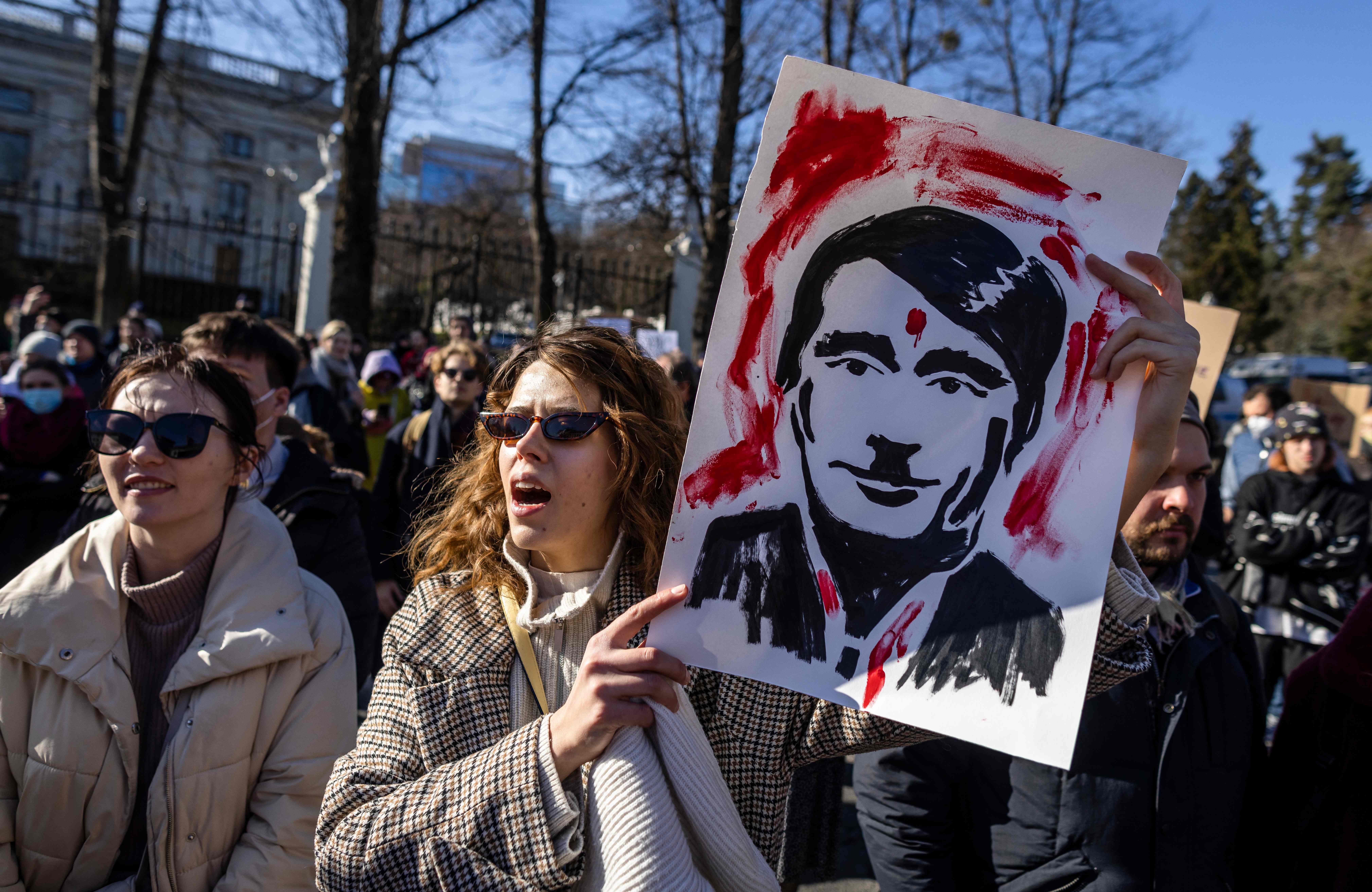 Ukrainian and Polish demonstrators take part in a protest against Russia's invasion of Ukraine, in front of the Russian embassy in Warsaw, Poland,