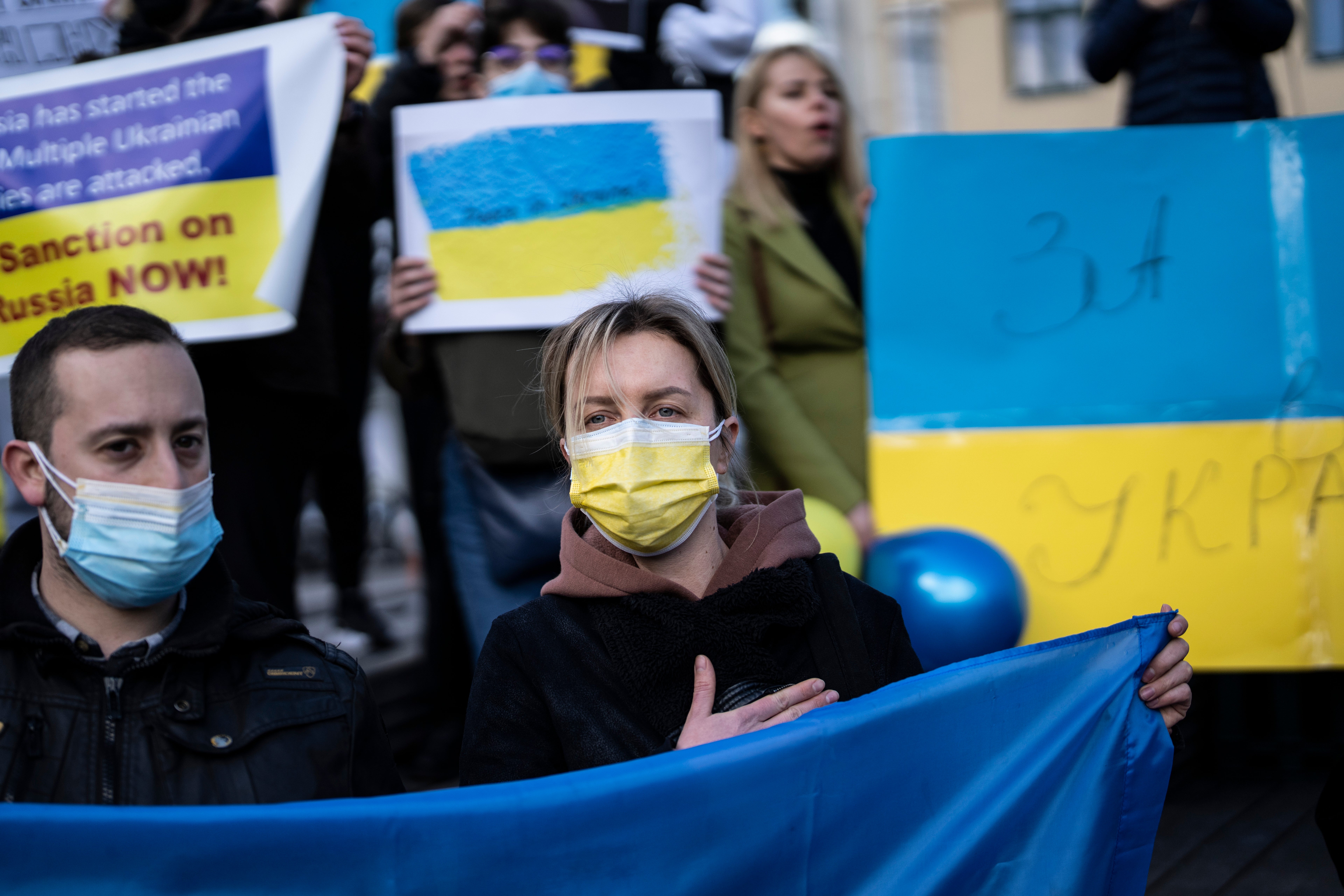 Ukrainians who live in Greece sing the national Anthem during a protest, against Russian attacks in Ukraine, in central Athens