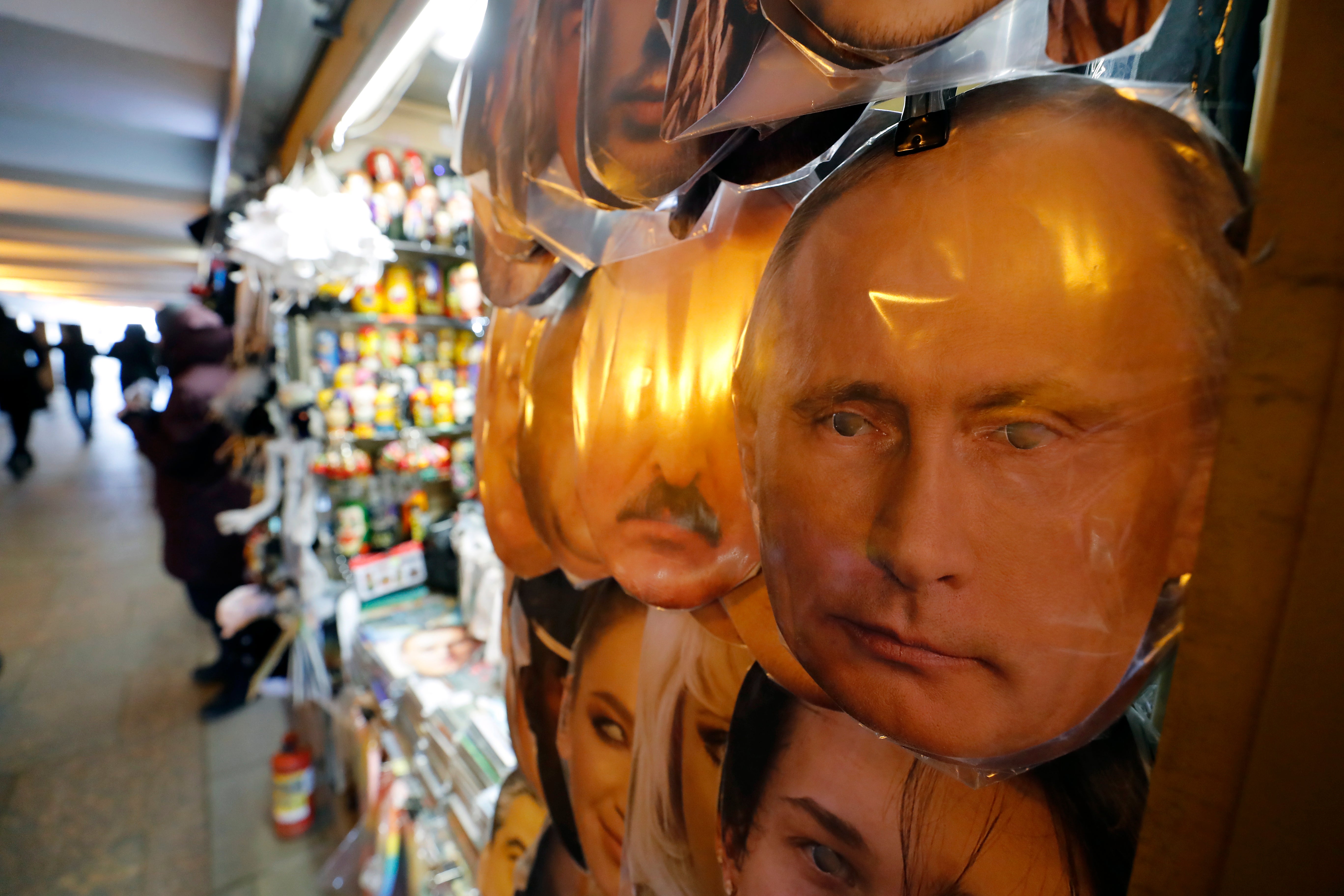 Masks with portraits of Russian President Vladimir Putin (R), and Belarus President Alexander Lukashenko on display in a street market as souvenirs in St. Petersburg