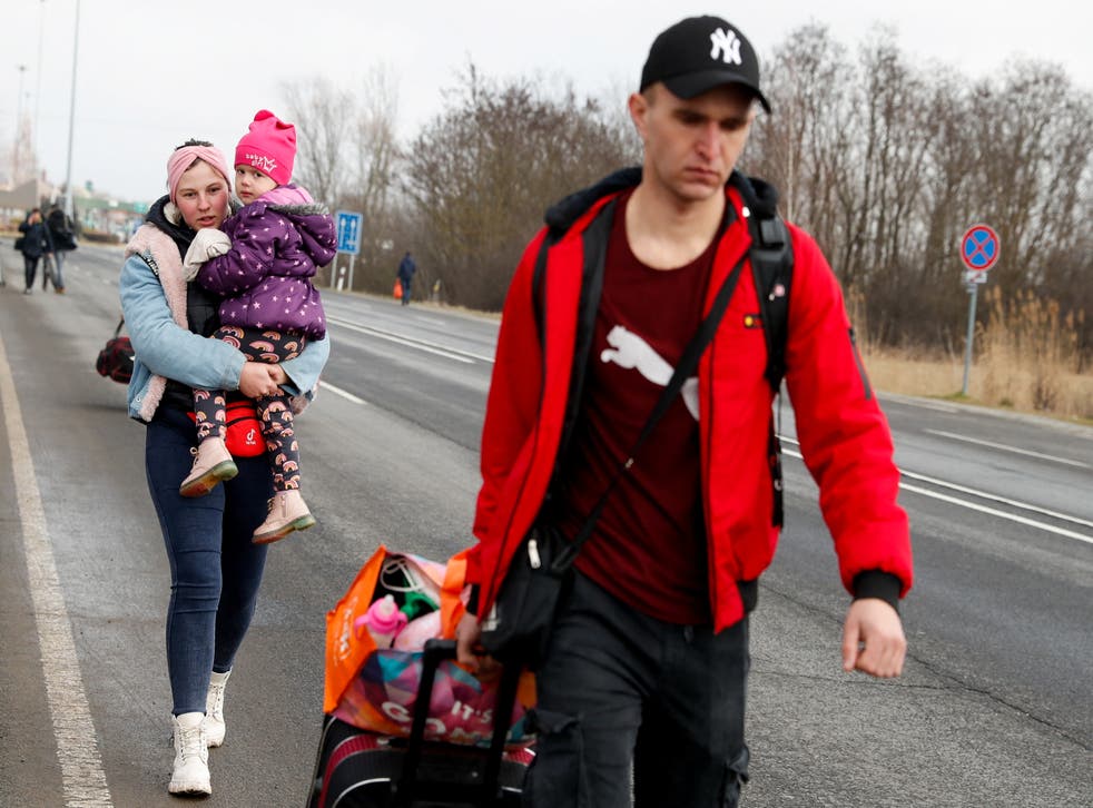 <p>People flee from Ukraine at the Hungarian-Ukrainian border on Thursday </p>