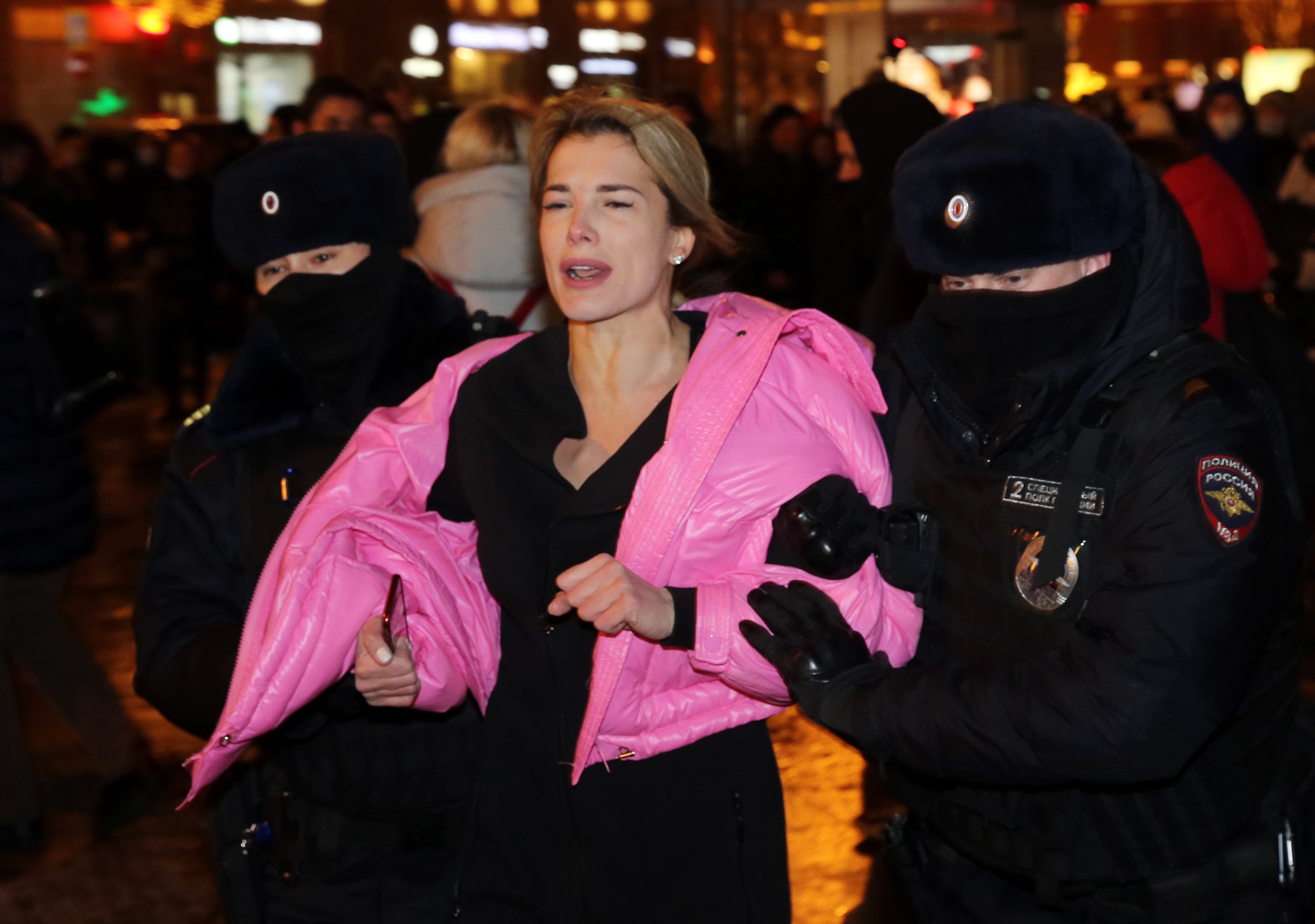 Russian police officers hold Ukrainian pop singer Olga Romanovskaya during a protest at Pushkinskaya Square