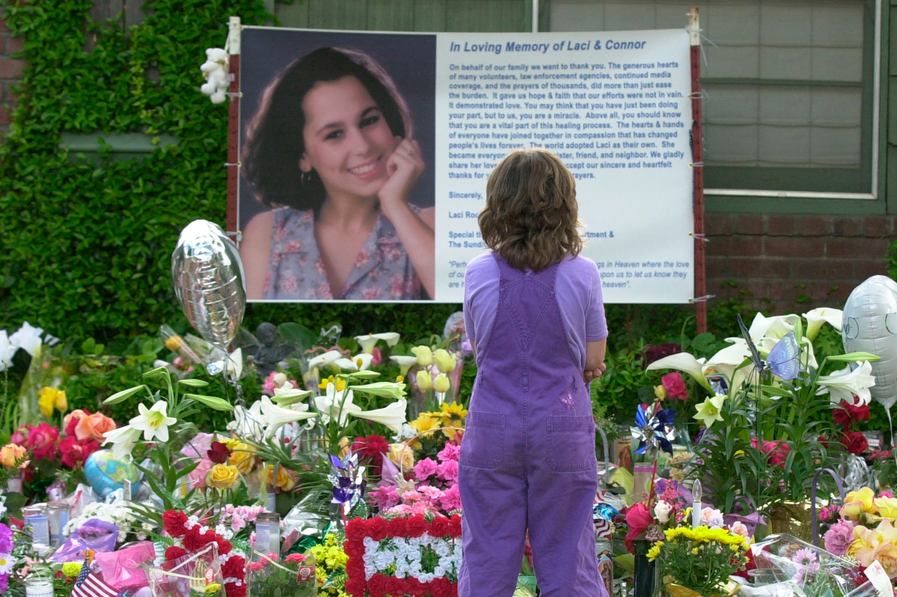 In this file shot, a mourner stands in front of a memorial to Laci Peterson in 2003