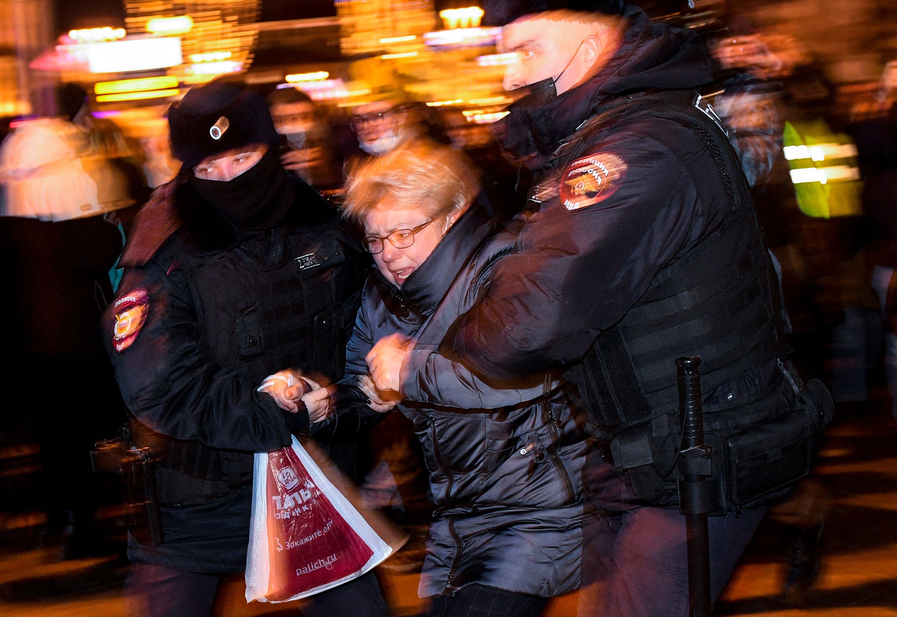 Police officers detain a demonstrator during a protest against Russia's invasion of Ukraine in Moscow on February 24, 2022