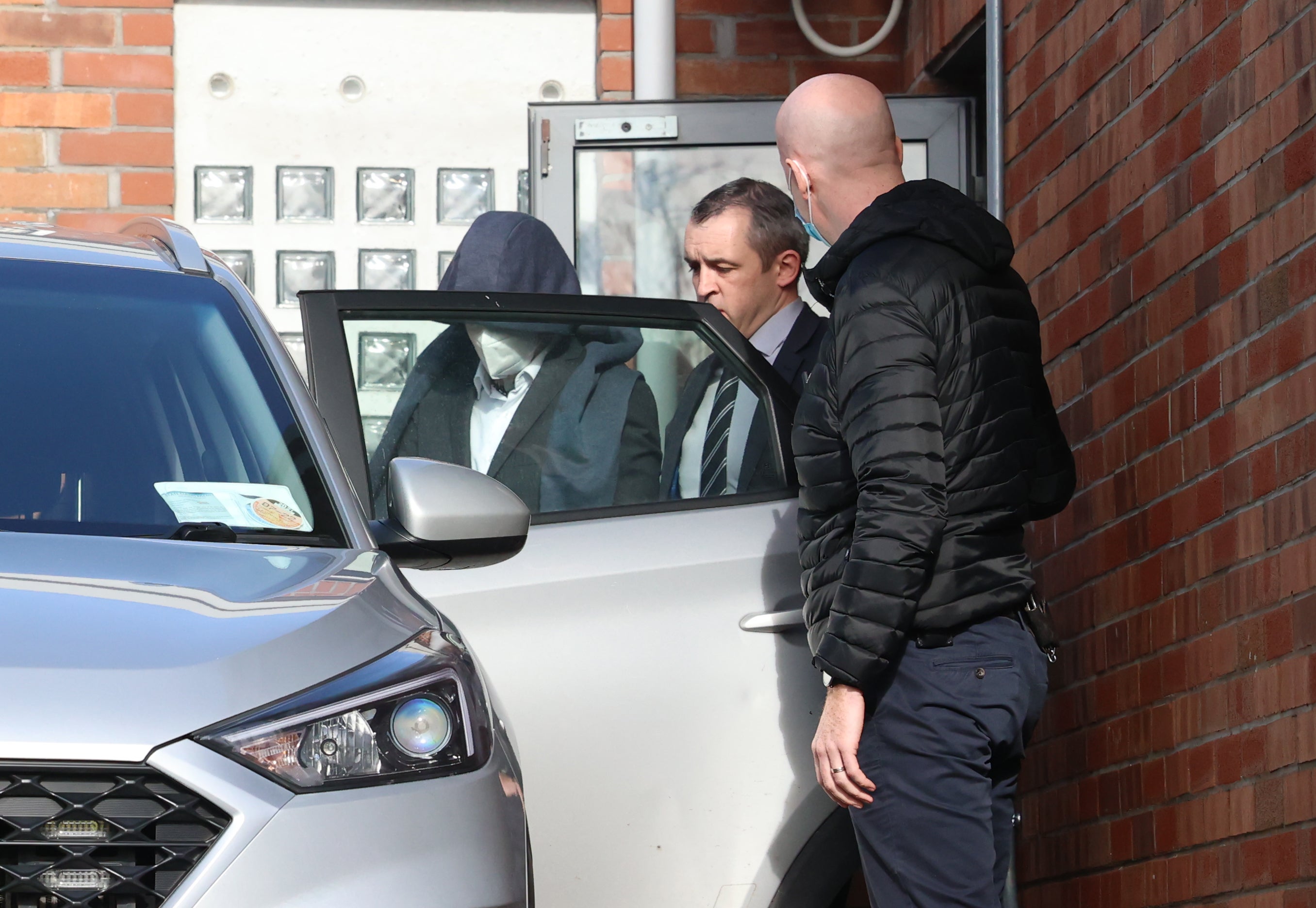 Diarmuid Phelan leaves Tallaght District Court in Dublin with his head covered (Sam Boal/PA)