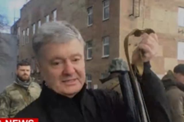 <p>Mr Poroshenko showed off a Kalashnikov </p>