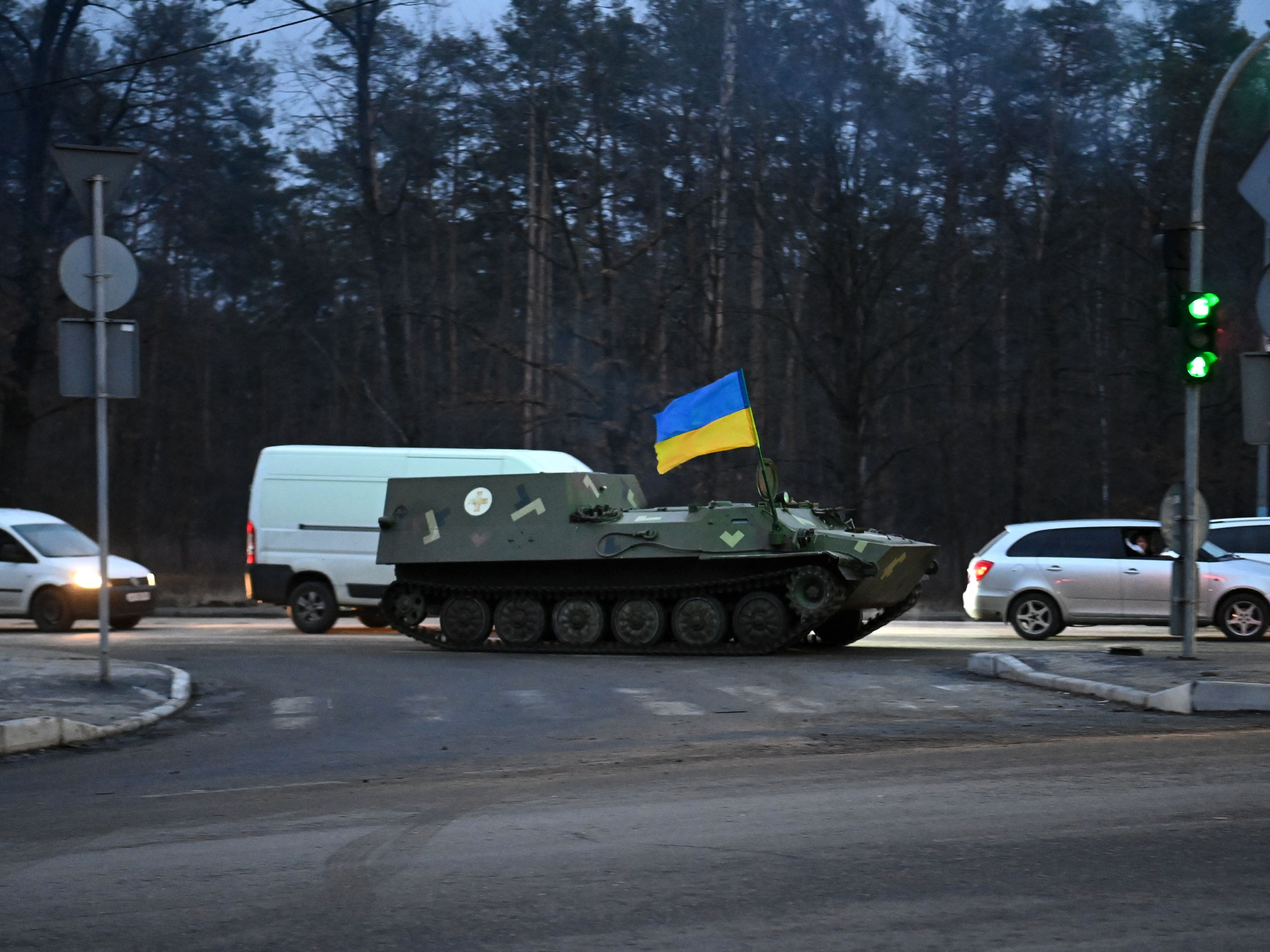 An armored medical evacuation vehicle, bearing the Ukrainian flag, on the road in northwest Kyiv on 24 February 2022