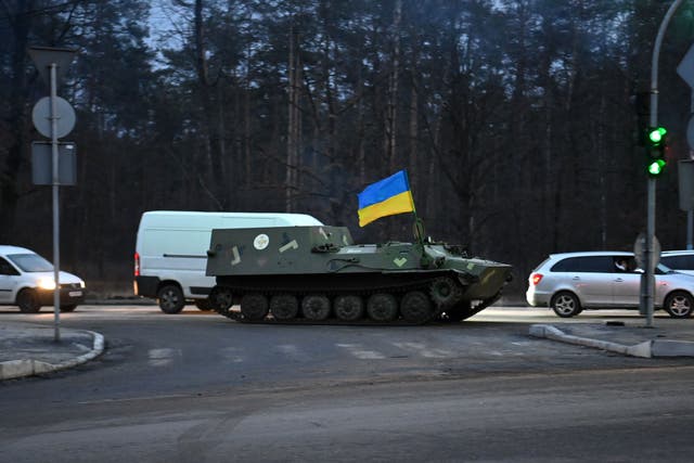 <p>An armored medical evacuation vehicle, bearing the Ukrainian flag, on the road in northwest Kyiv on 24 February 2022</p>