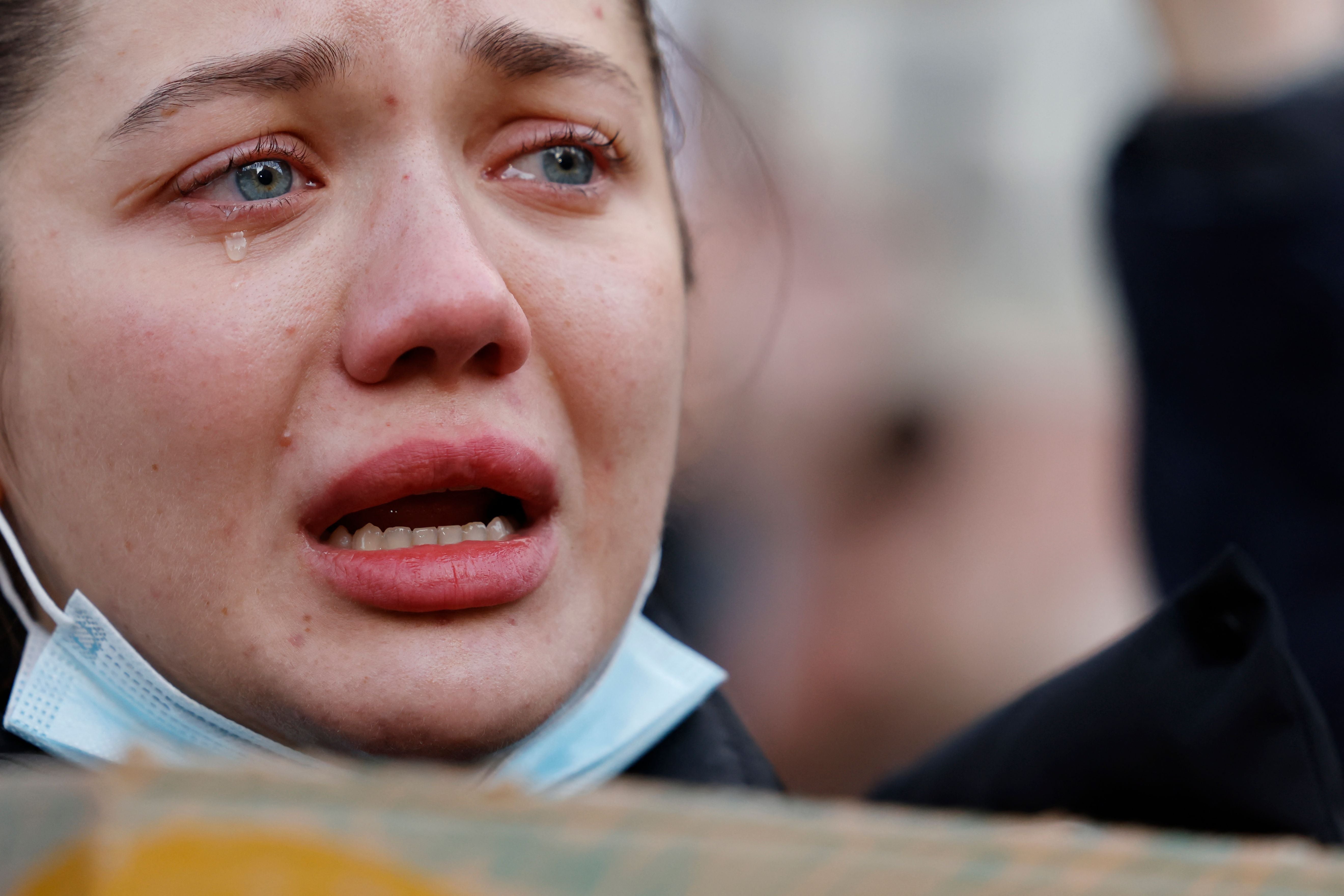 A demonstrator cries holding a placard at a rally staged in front of the Downing Street gates, London