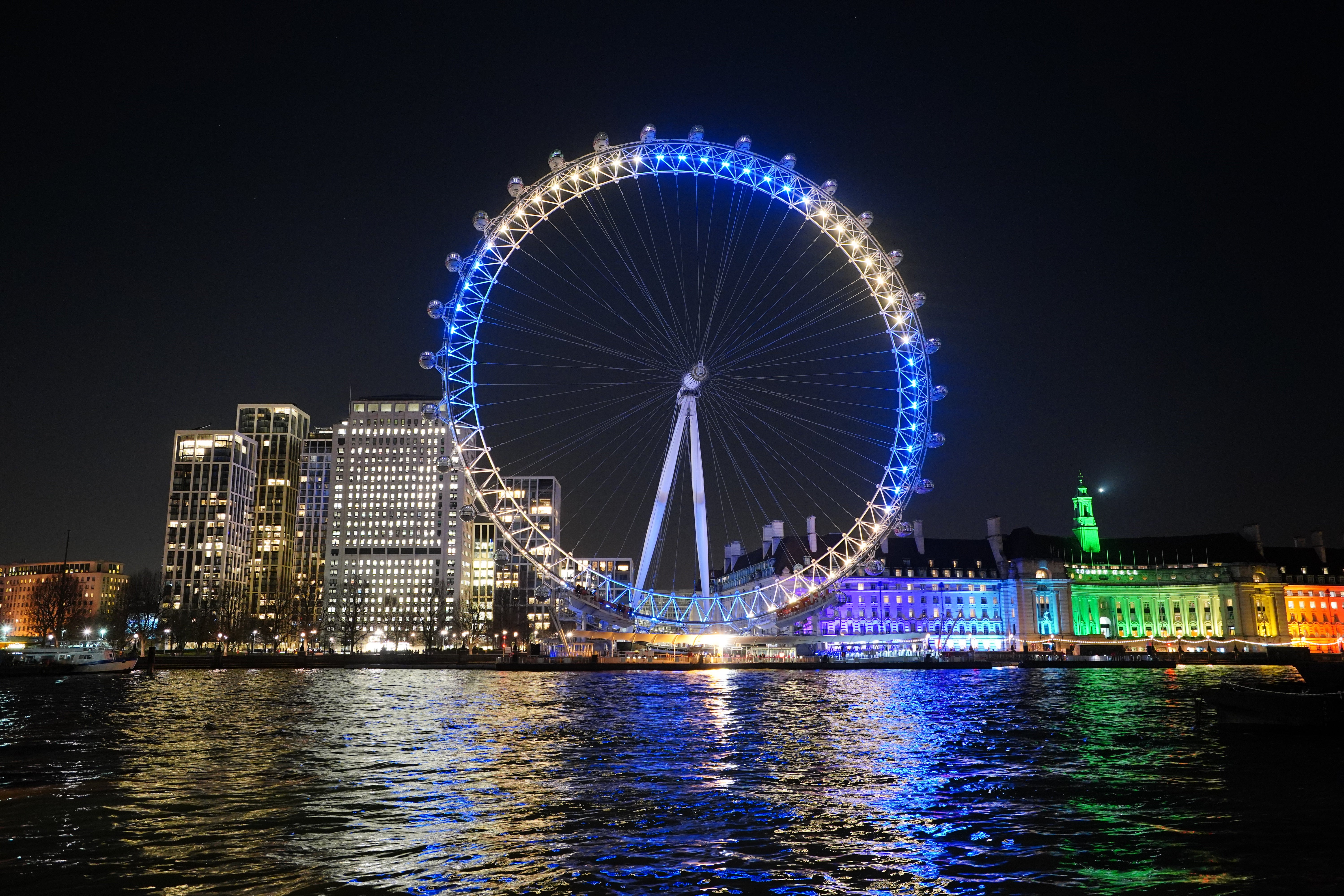 The lastminute.com London Eye in London is lit up in yellow and blue in an expression of solidarity with Ukraine following Russia’s invasion (Dominic Lipinski/PA)