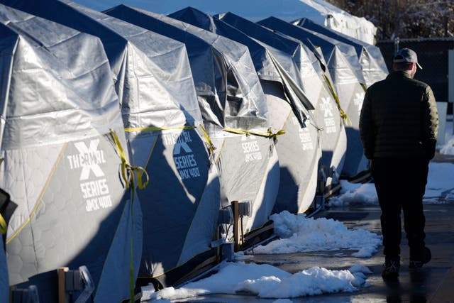 <p>Tents stand in a long row at the east safe outdoor space in the parking lot of the city of Denver Human Service building in Denver</p>