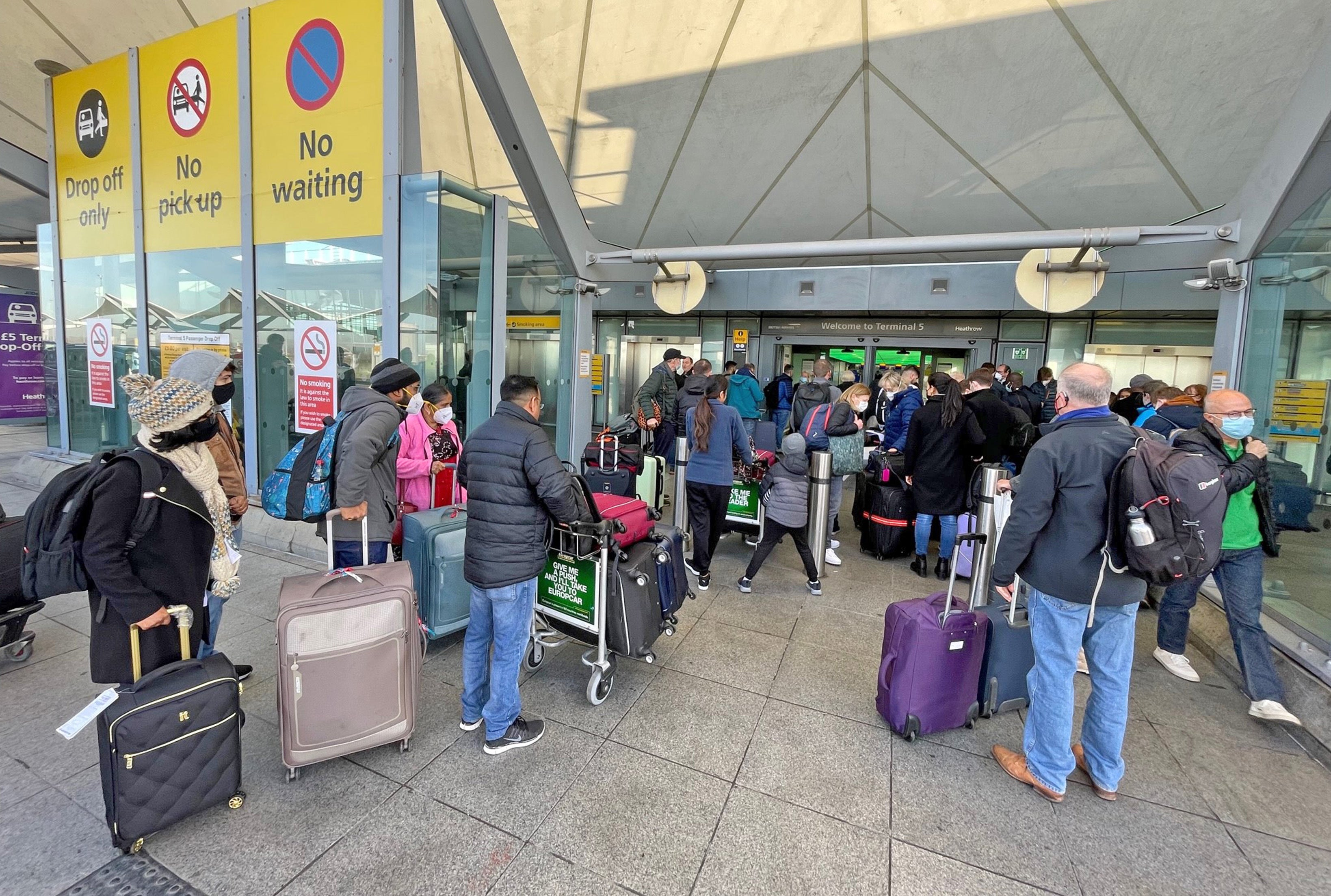Passengers queue at the Arrivals entrance of Heathrow Airport T5, London (PA/Jonathan Brady)