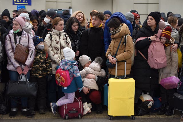 <p>People wait for a train to Poland at the railway station in the western Ukrainian city of Lviv</p>