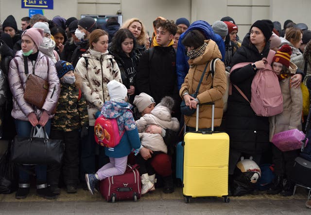 <p>People wait for a train to Poland at the railway station in the western Ukrainian city of Lviv</p>