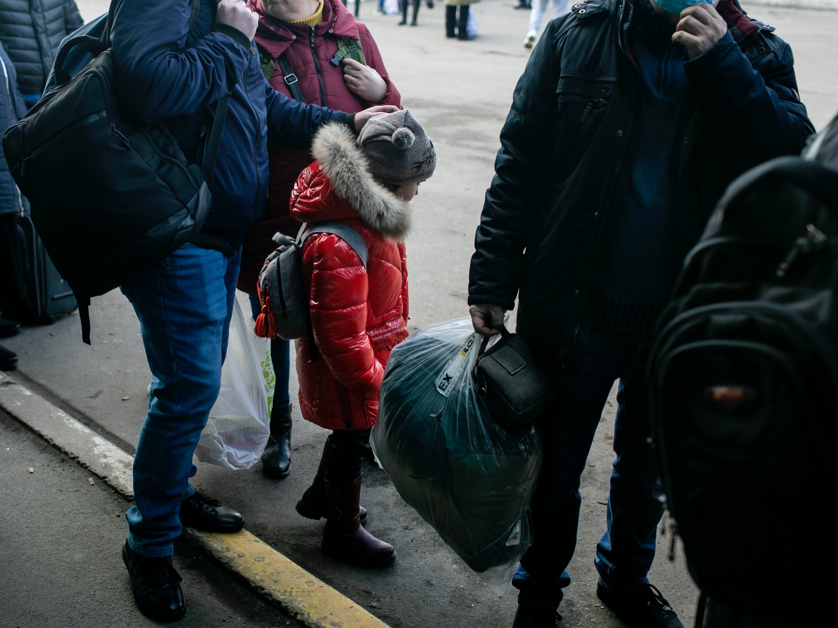 <p>People waiting for a bus to take them out of Kyiv, Ukraine</p>