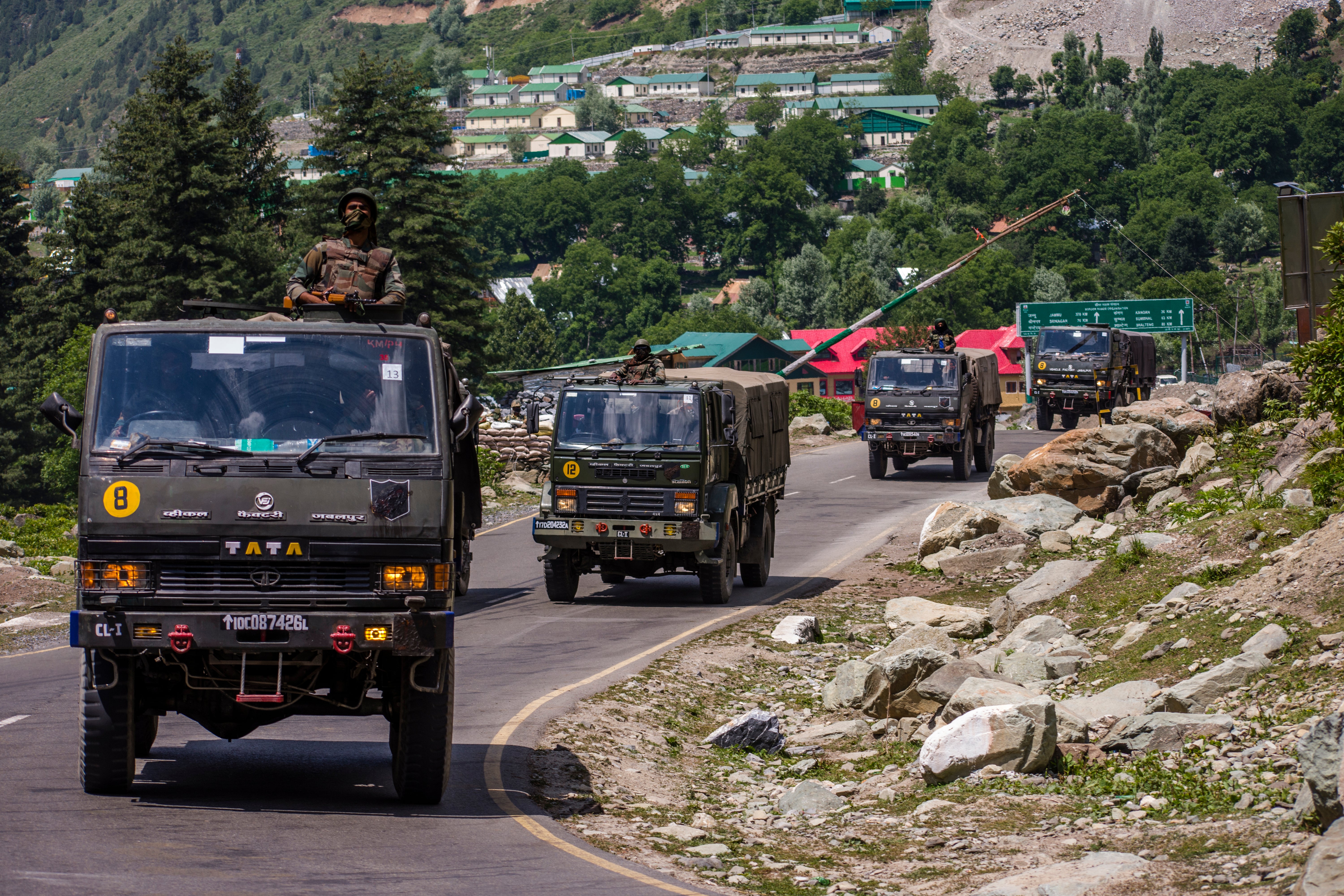 An Indian army convoy drives towards Leh, on a highway bordering China, in Gagangir, India, 19 June 2020