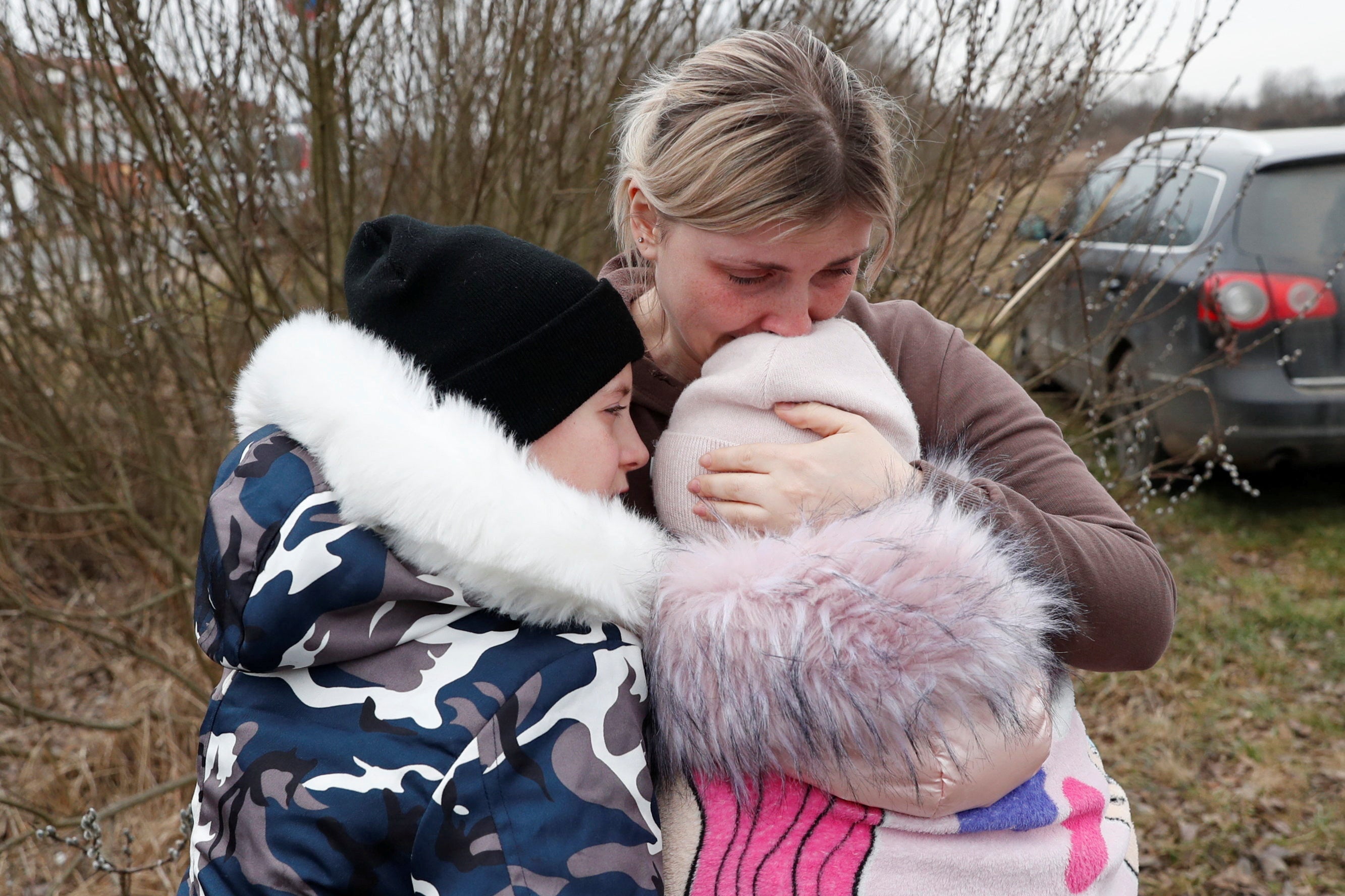 Anna Semyuk, 33, hugs her children, after a stranger took them across the border and kept them safe in Hungary