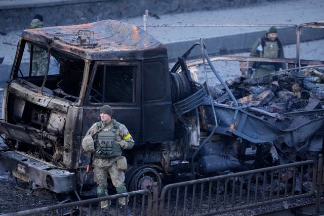 <p>Ukrainian troops inspect the site following a Russian airstrike in Kyiv, Ukraine, Saturday, Feb. 26, 2022. </p>