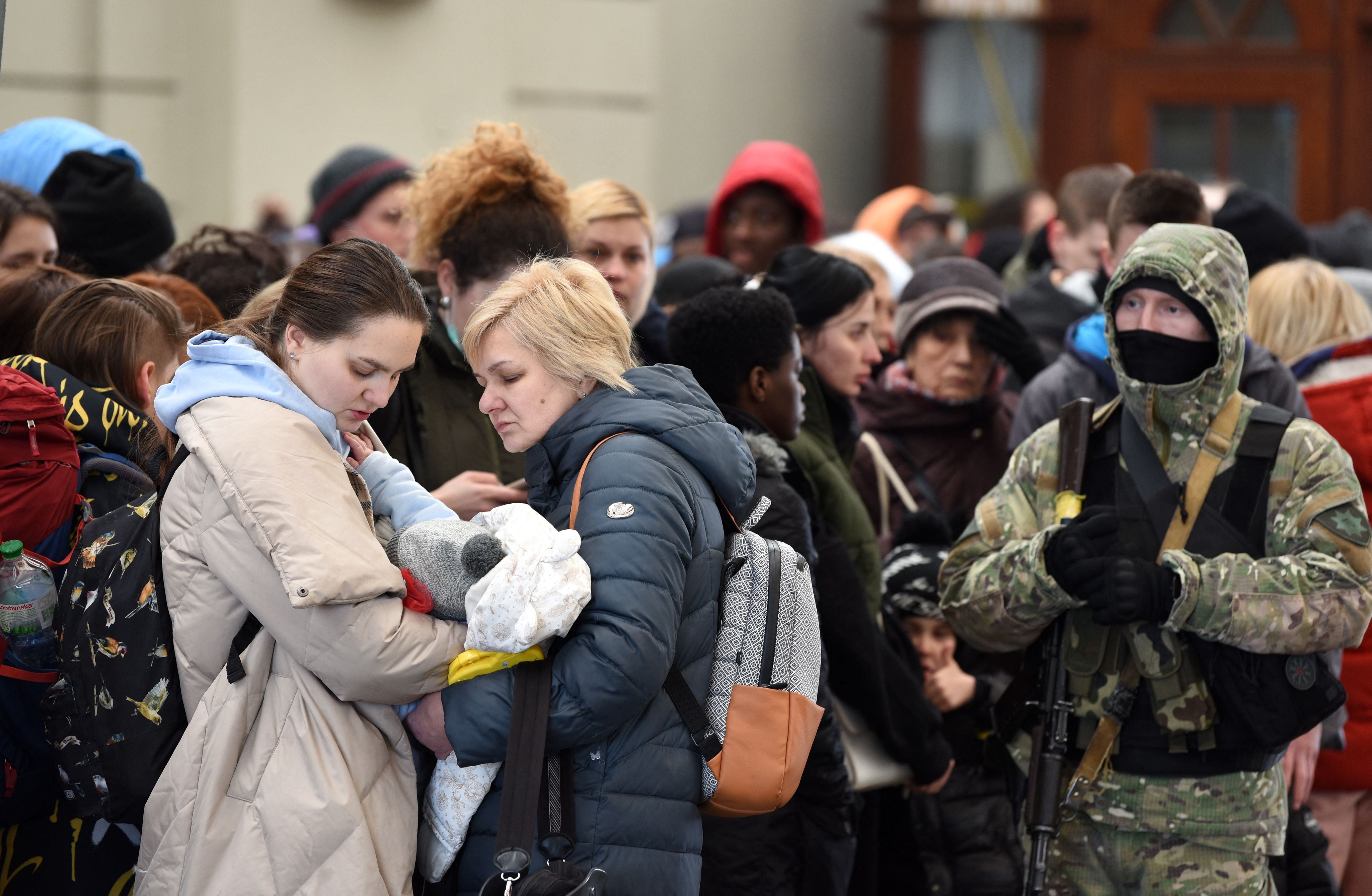 People wait for a train to Poland at the railway station of the western Ukrainian city of Lviv on February 26, 2022