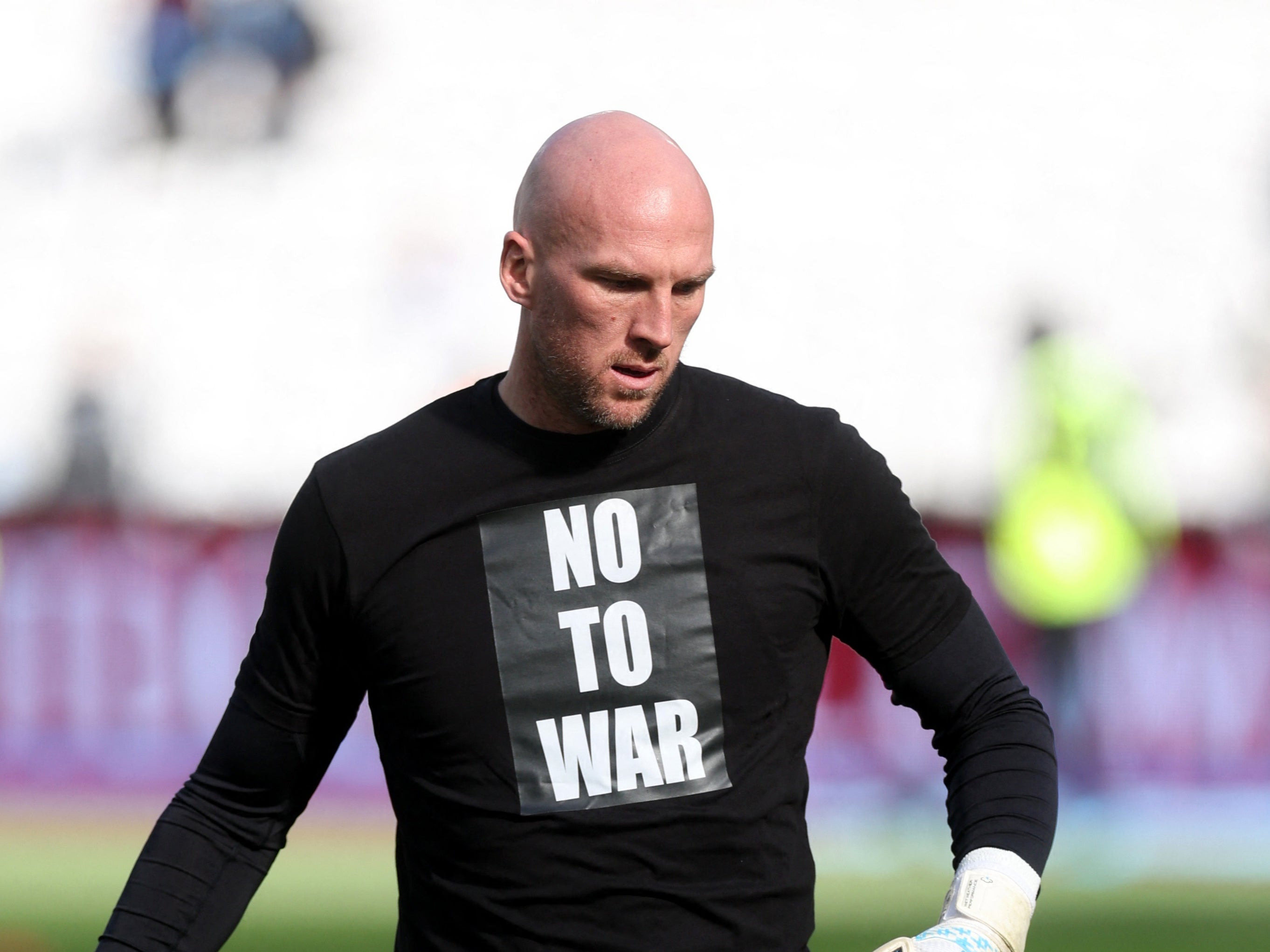 John Ruddy wears a no to war shirt in support of Ukraine