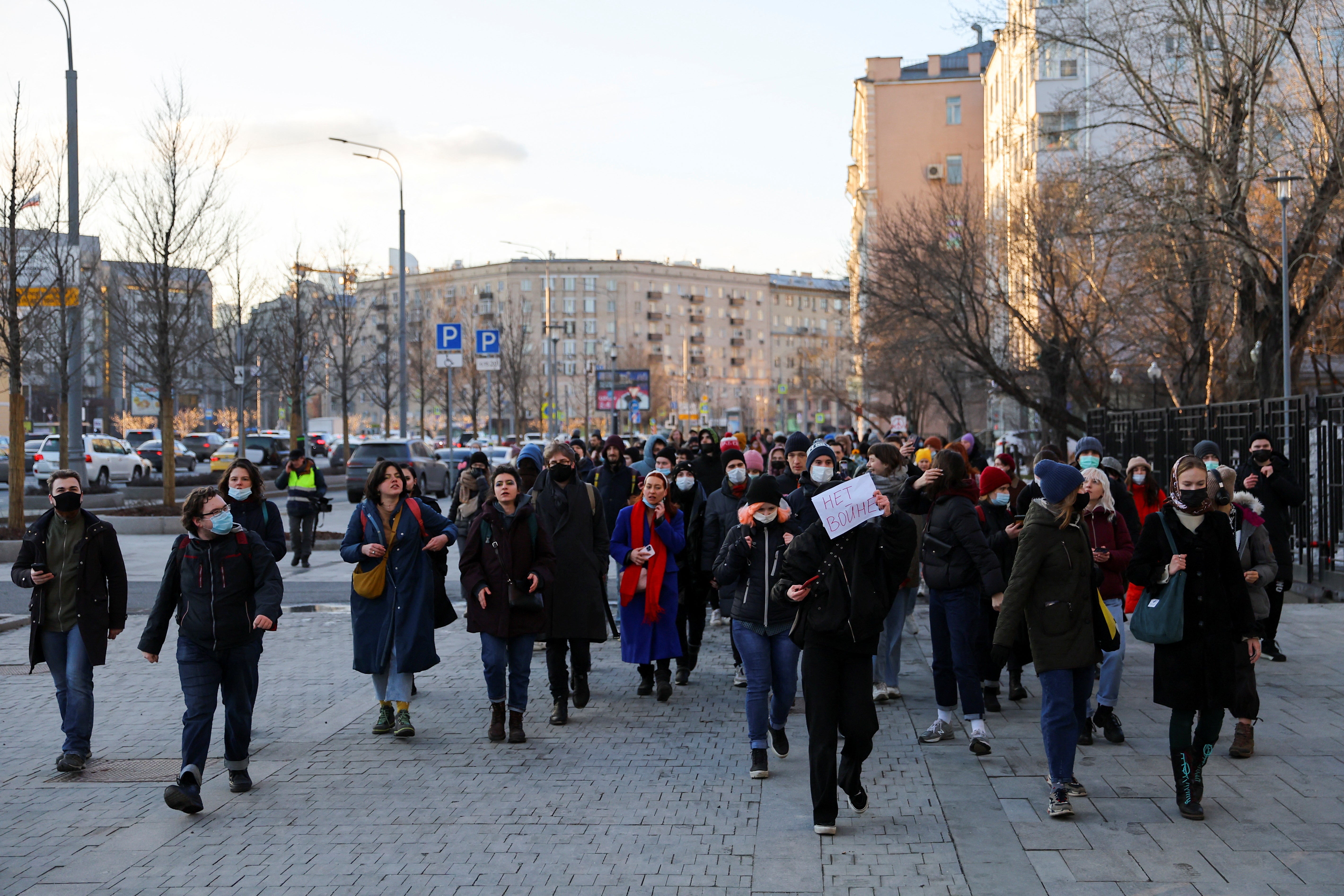 People wearing masks with the slogan "no war" attend a protest against Russian invasion of Ukraine, after President Vladimir Putin authorised a massive military operation, in Moscow, Russia February 27, 2022