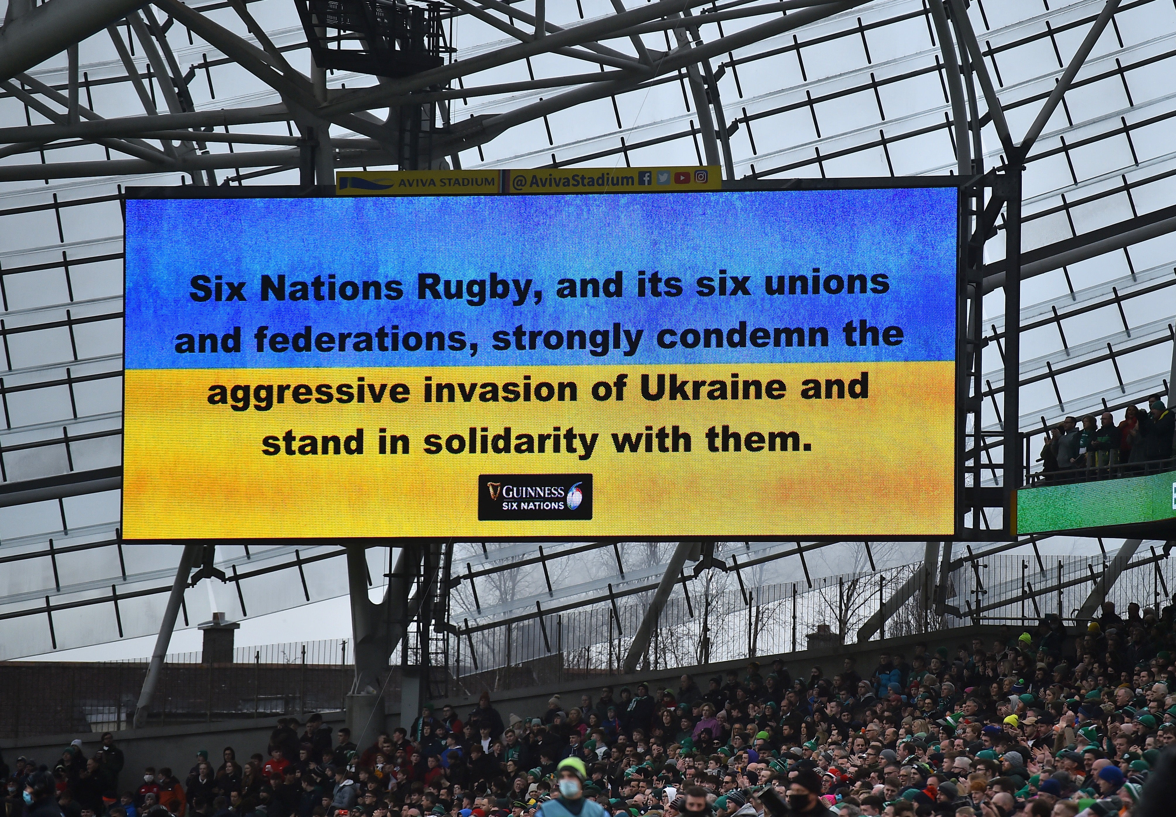 A message in support of Ukraine is shown inside the stadium before the match