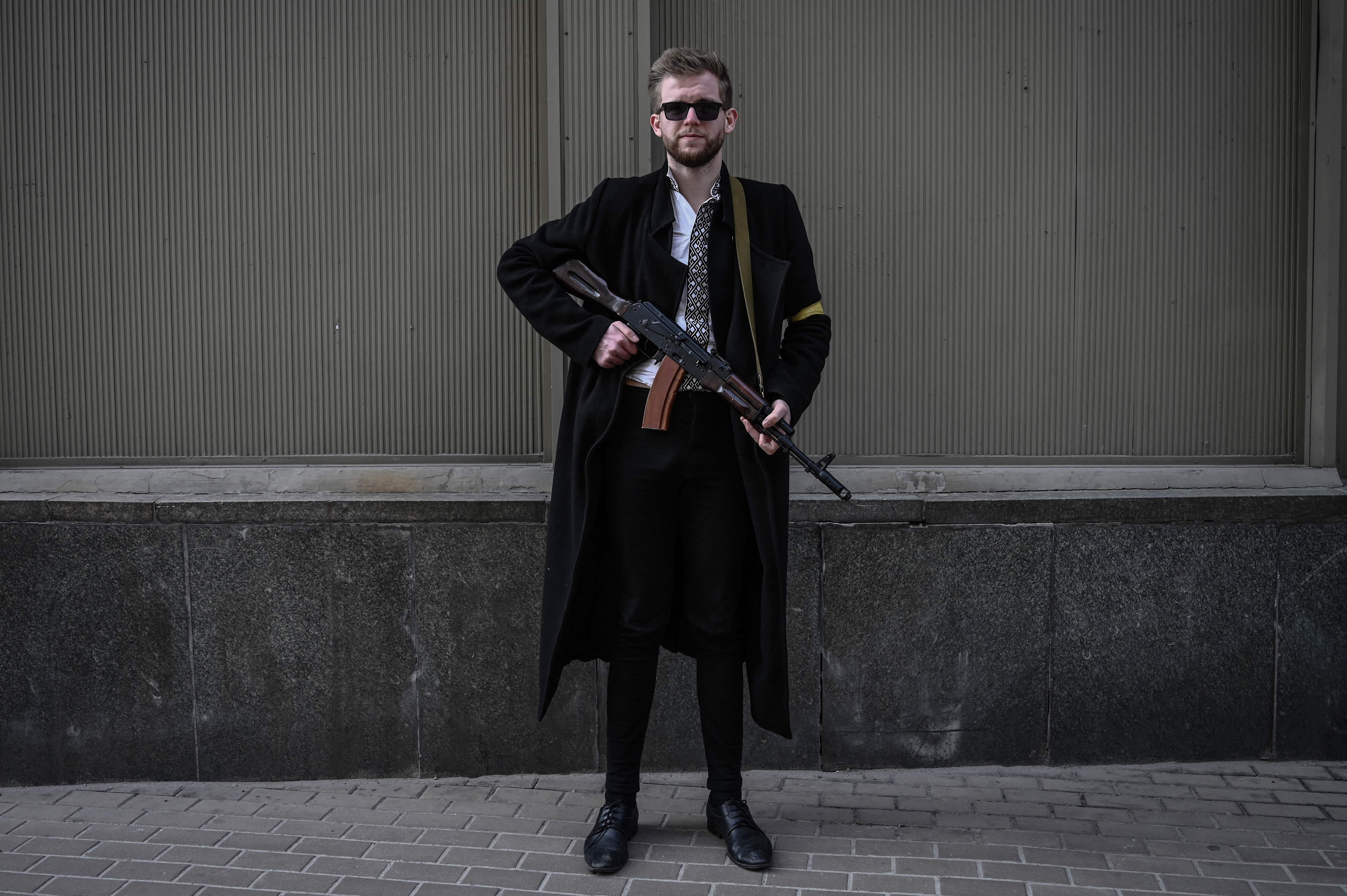 Sviatoslav Yurash, 26, a lawmaker from Zelensky’s Servant of the People party, poses with his assault rifle as he patrols downtown Kyiv