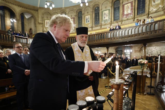 <p>Boris Johnson lights a candle during a visit to the Ukrainian Catholic Eparchy of Holy Family of London</p>