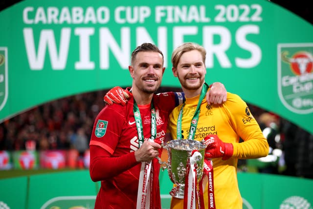 Liverpool’s Jordan Henderson and goalkeeper Caoimhin Kelleher celebrate with the Carabao Cup trophy (Nick Potts/PA)