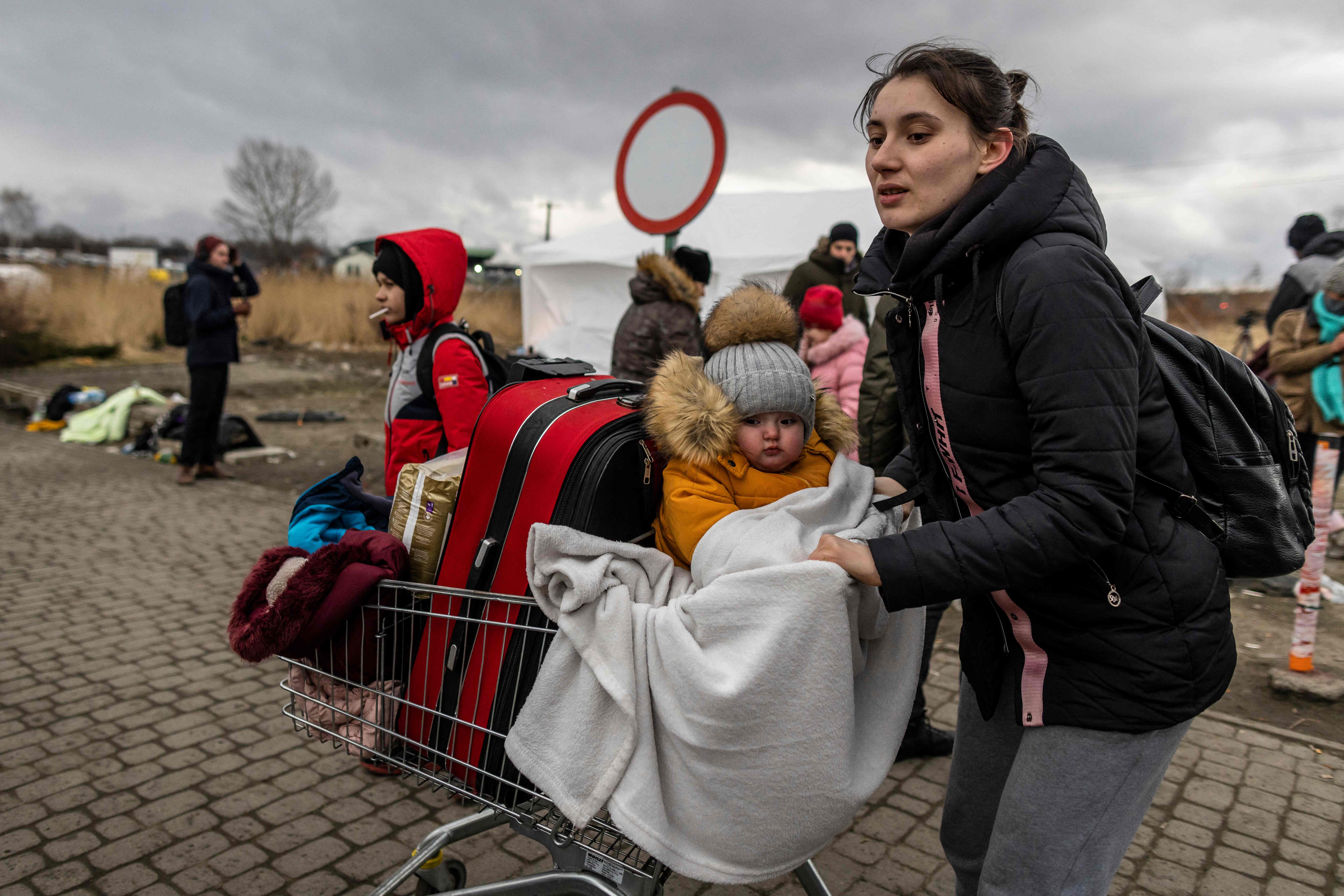 <p>A Ukrainian mother and her child arrive at the Medyka pedestrian border into eastern Poland on Sunday </p>