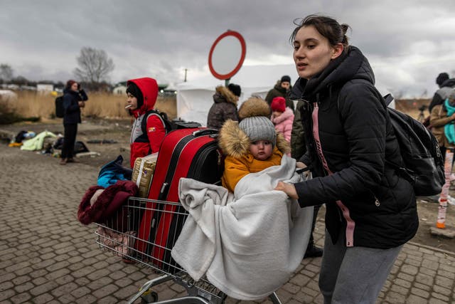 <p>A Ukrainian mother and her child arrive at the Medyka pedestrian border into eastern Poland on Sunday </p>