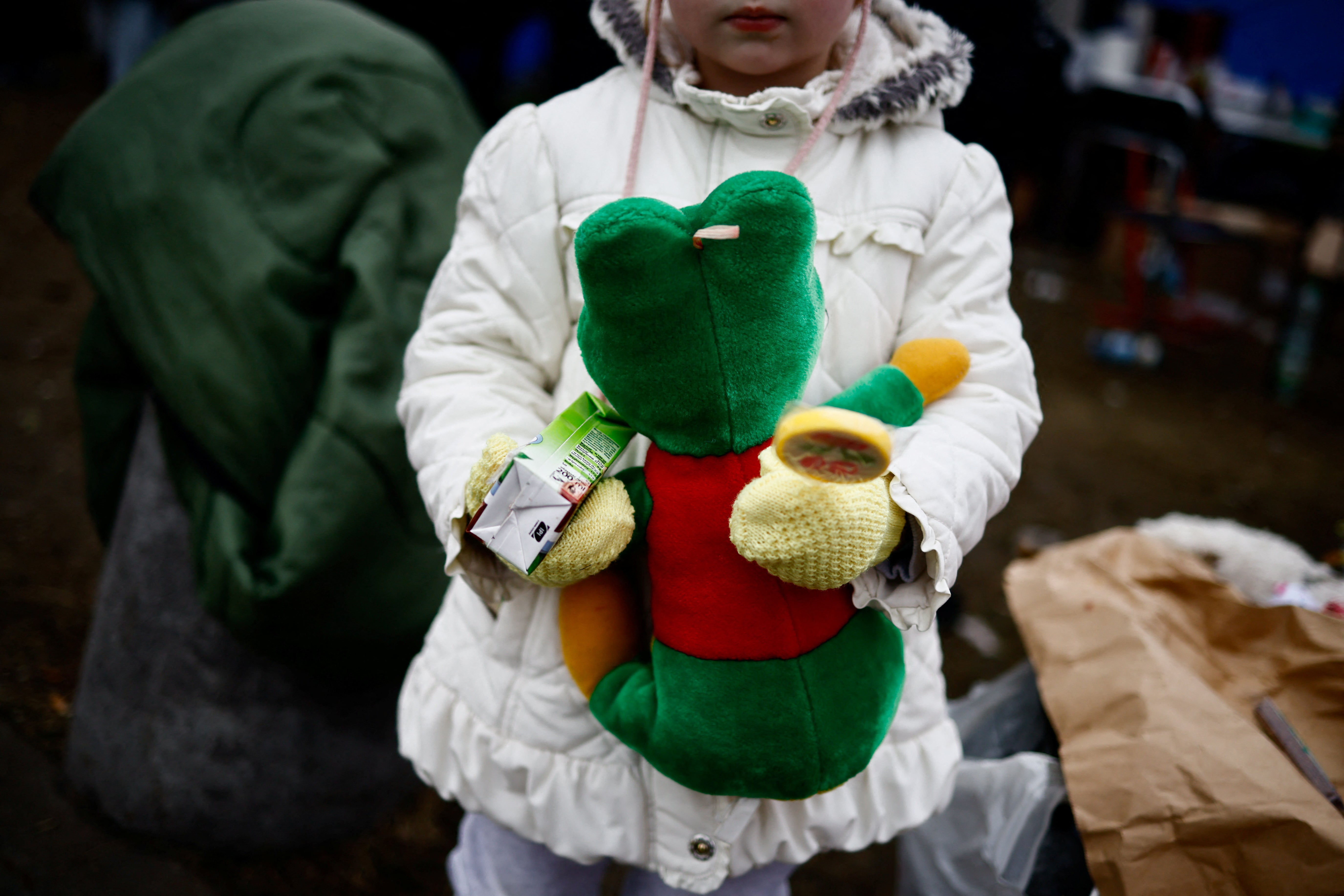 A child fleeing Russian invasion of Ukraine holds a toy at a temporary camp in Przemysl, Poland