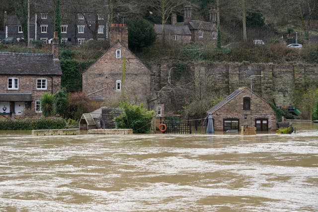 Flooded properties next to the River Severn following high winds and wet weather in Ironbridge, Shropshire (Jacob King/PA)
