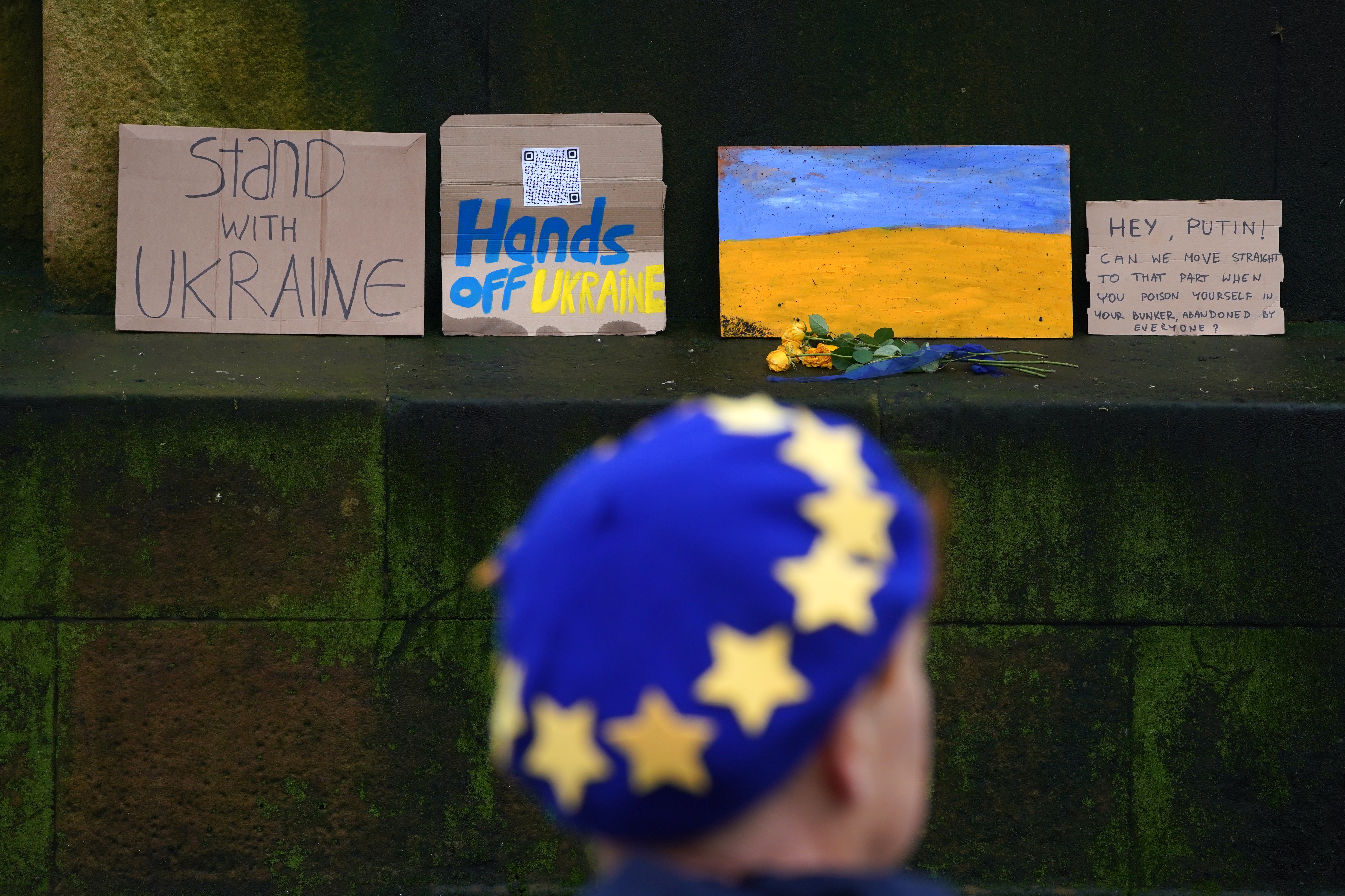 People take part in a protest against the Russian invasion of Ukraine in George Square, Glasgow (PA)