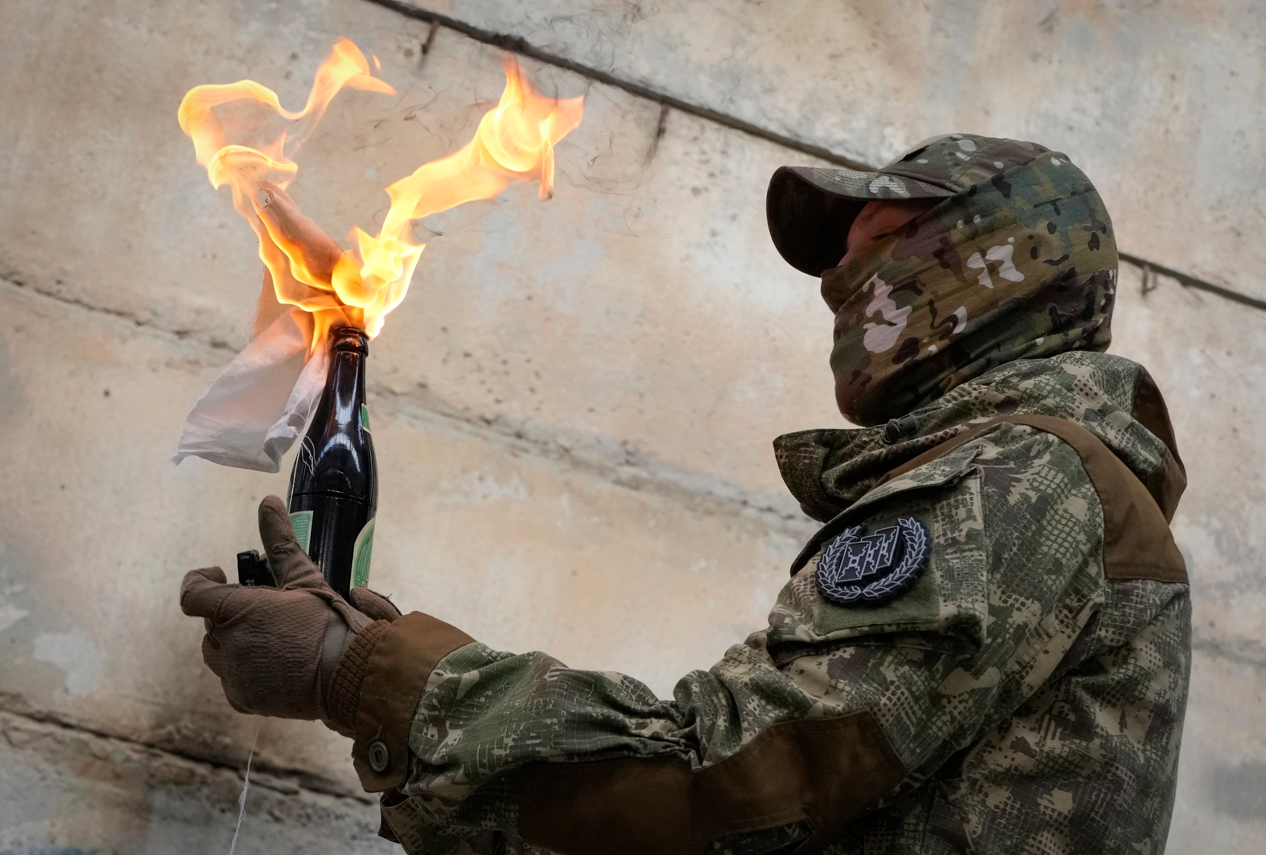 A resident prepares to use a Molotov cocktail during an all-Ukrainian training campaign