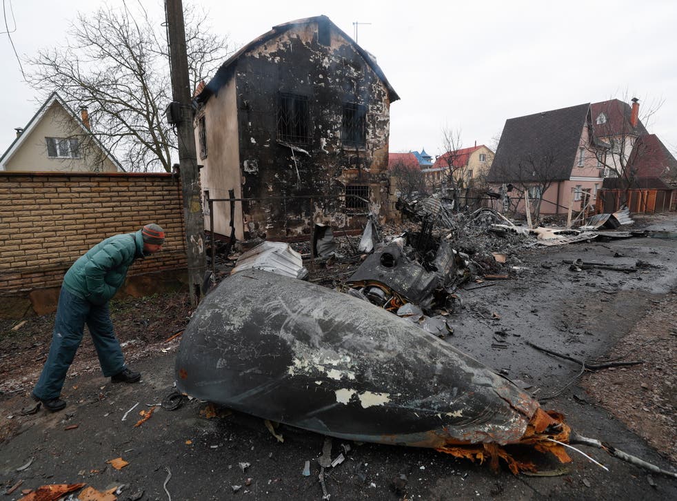 <p>A man looks at the debris of a military plane that was shot down overnight in Kyiv</p>